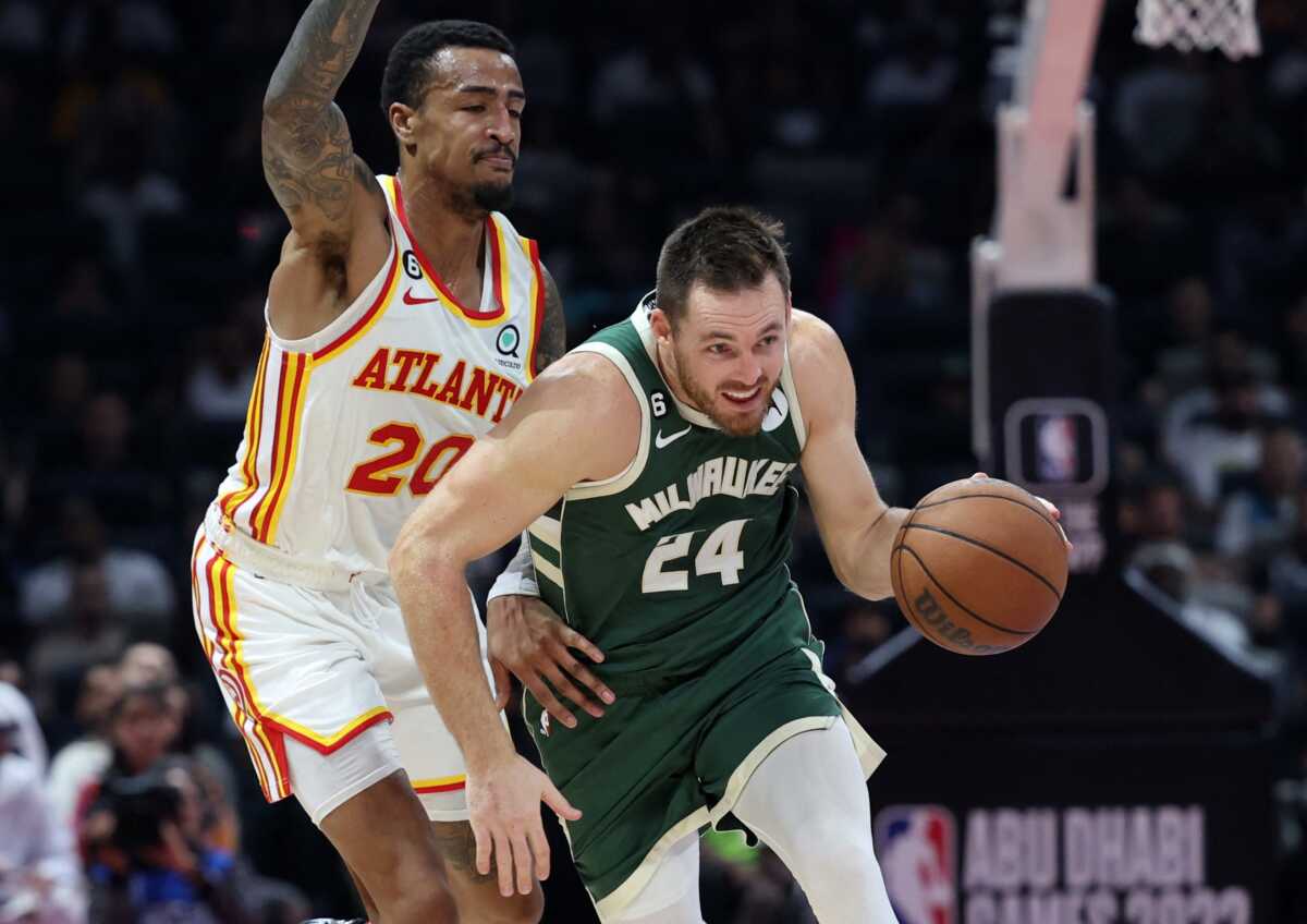 Basketball - NBA Pre-season game - Atlanta Hawks v Milwaukee Bucks - Etihad Arena, Abu Dhabi, United Arab Emirates - October 8, 2022 Milwaukee Bucks's Pat Connaughton in action with Atlanta Hawks' John Collins REUTERS