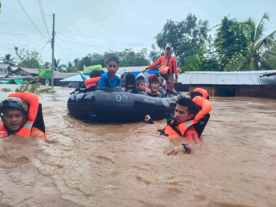 Philippine Coast Guard (PCG) rescuers evacuate residents from their flooded homes due to a tropical storm, locally named Paeng, in Maguindanao province, Philippines, October 28, 2022. Philippine Coast Guard
