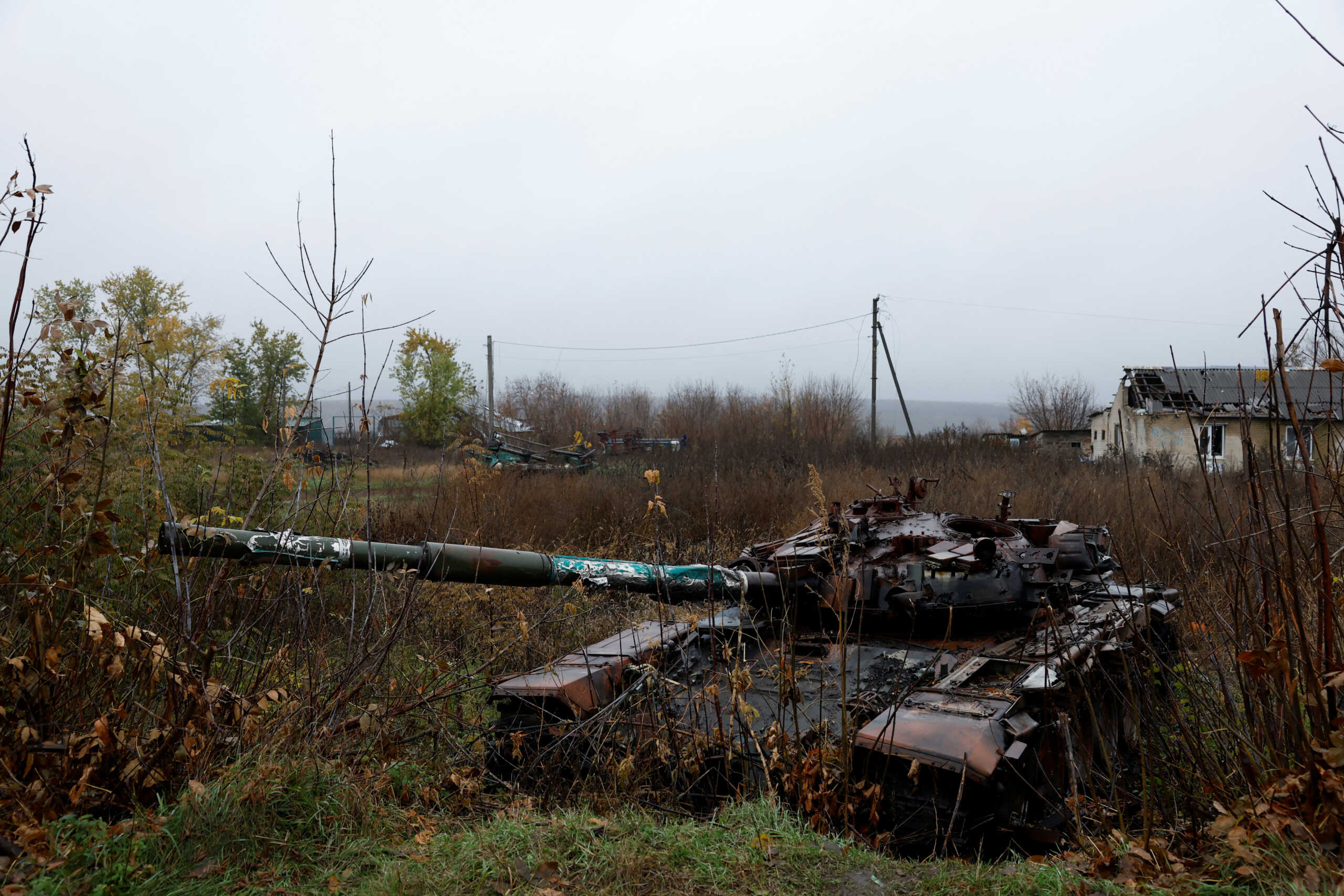 A destroyed tank is seen in the village where Myhaylo Yurkiv, 65, stayed in a bunker for six months during fierce battles under Russian occupation which destroyed his home and cut the village in two by the shelling of the bridge, leaving him now as the only person living on his side of the village, as Russia's invasion of Ukraine continues, in Tsupivka, Ukraine, October 26, 2022. REUTERS