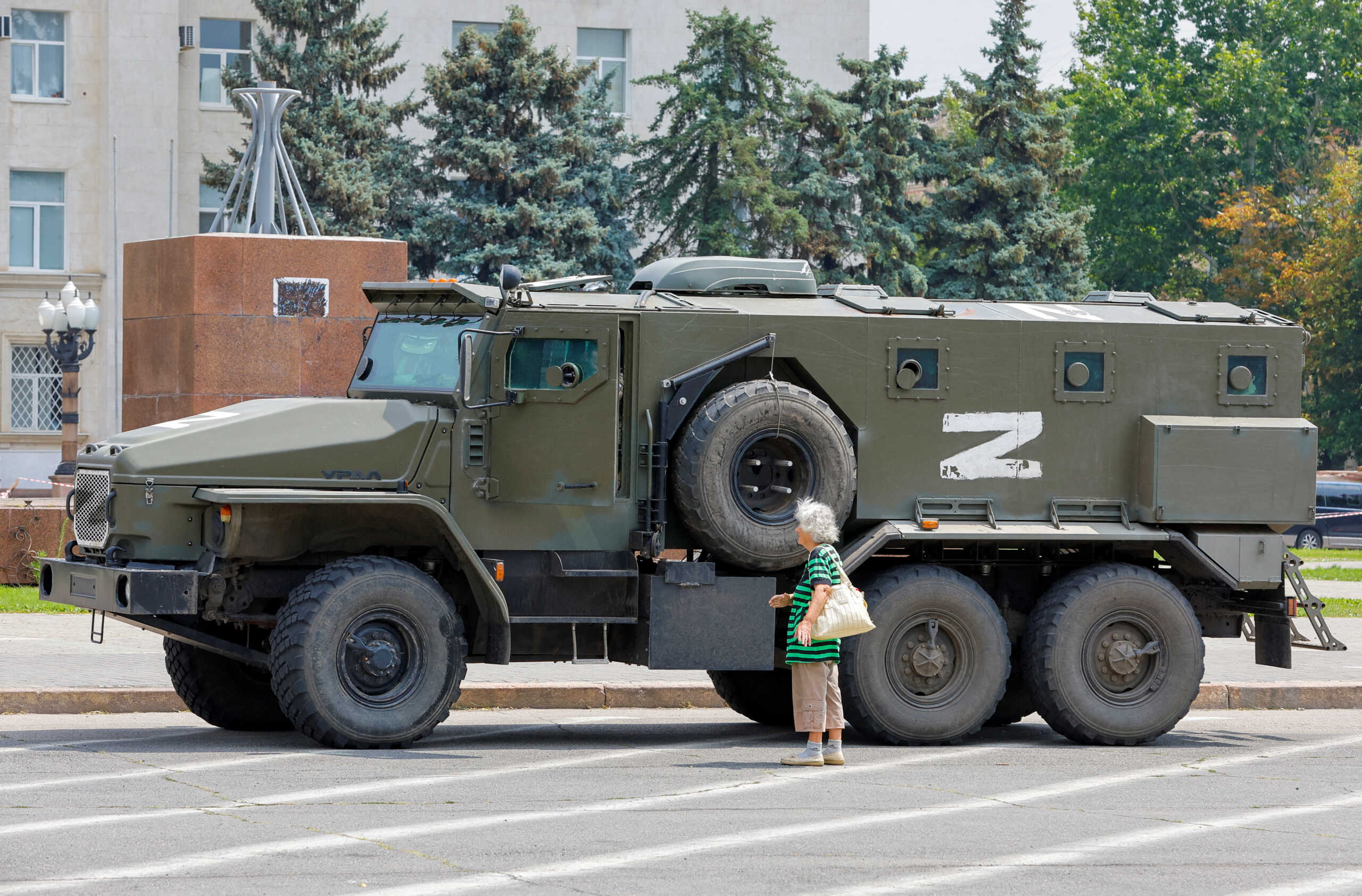 FILE PHOTO: An armoured truck of pro-Russian troops is parked near Ukraine's former regional council's building during Ukraine-Russia conflict in the Russia-controlled city of Kherson, Ukraine July 25, 2022. REUTERS