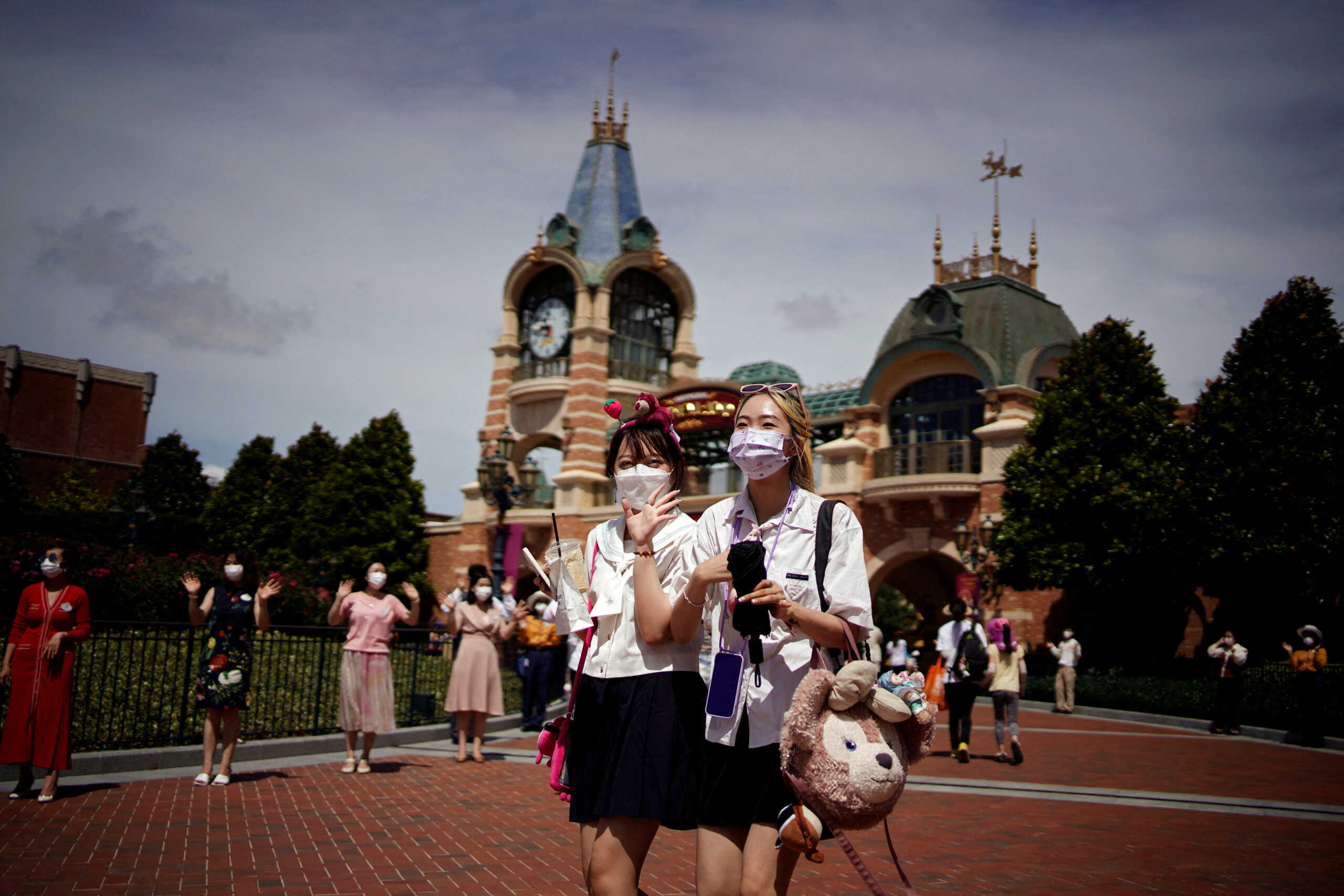FILE PHOTO: People wearing face masks visit the Shanghai Disney Resort, as the Shanghai Disneyland theme park reopens after being shut for the coronavirus disease (COVID-19) outbreak, in Shanghai, China June 30, 2022. REUTERS