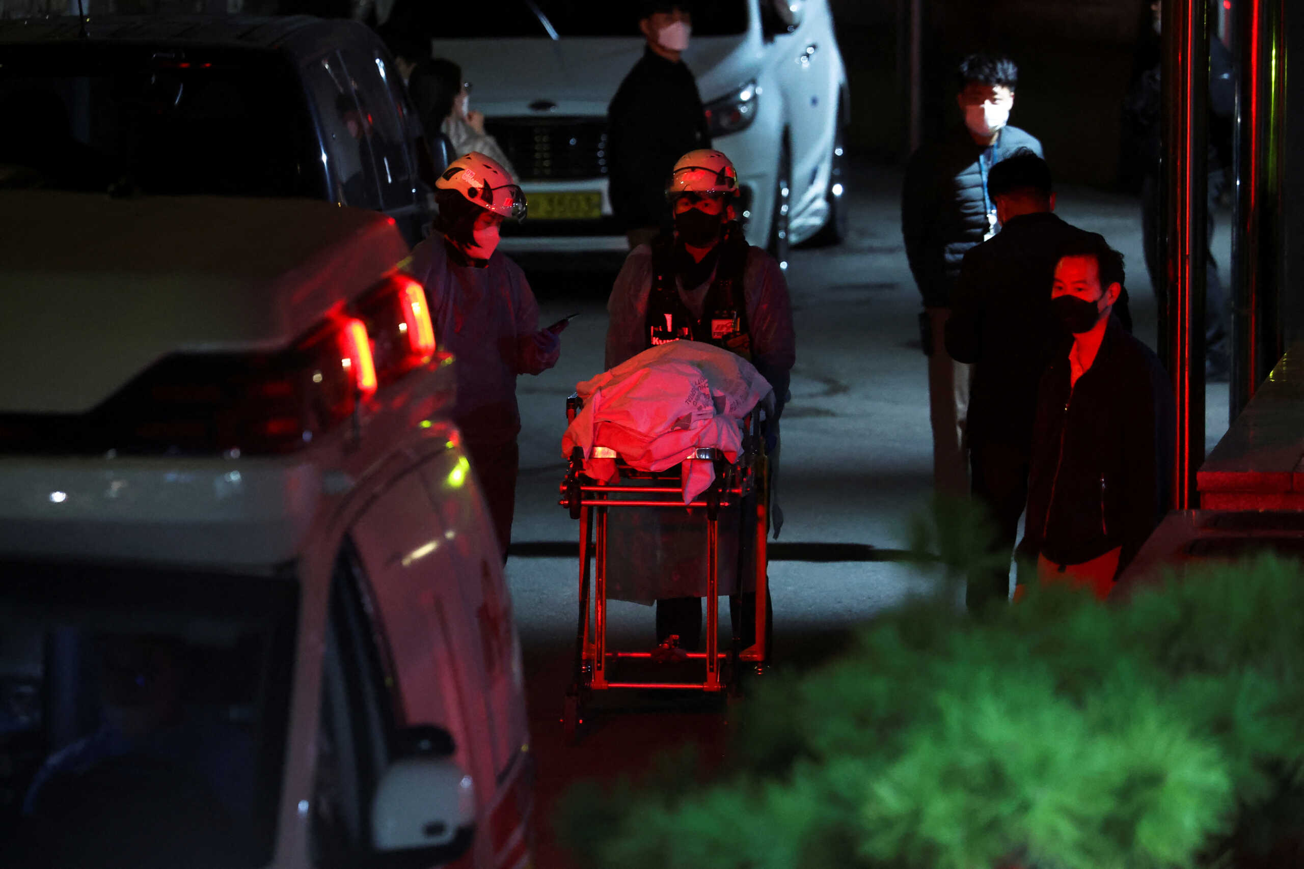 A body is wheeled into an ambulance for transport at a hospital, after a stampede during a Halloween festival in Seoul, South Korea, October 30, 2022. REUTERS