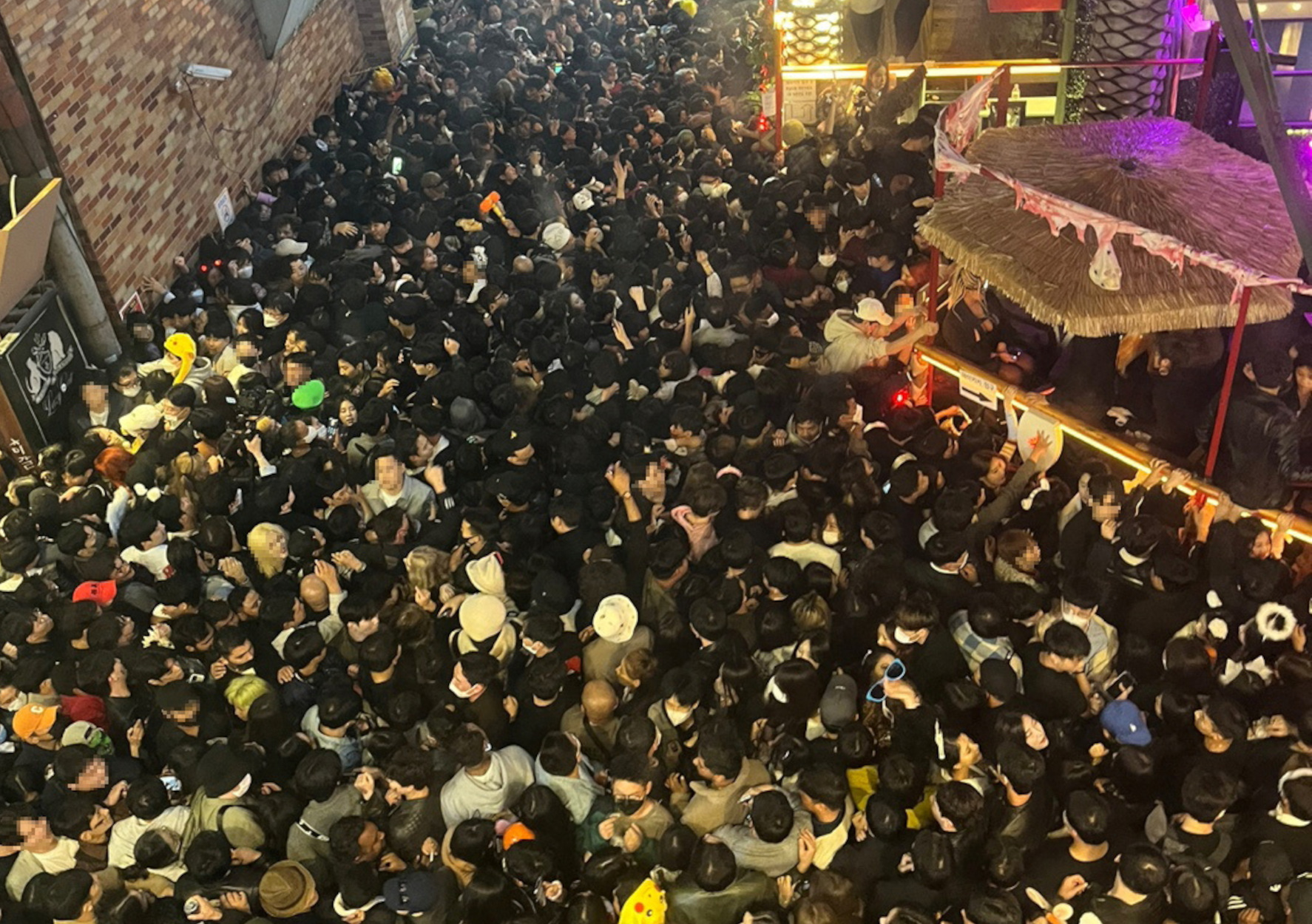 A street in Itaewon district is pictured full of people before a stampede during Halloween festivities killed and injured many in Seoul, South Korea, in this image released by Yonhap on October 30, 2022. Yonhap via REUTERS ATTENTION EDITORS - THIS IMAGE HAS BEEN SUPPLIED BY A THIRD PARTY. SOUTH KOREA OUT. NO RESALES. NO ARCHIVES. THE IMAGE HAS BEEN PIXELATED AT SOURCE.