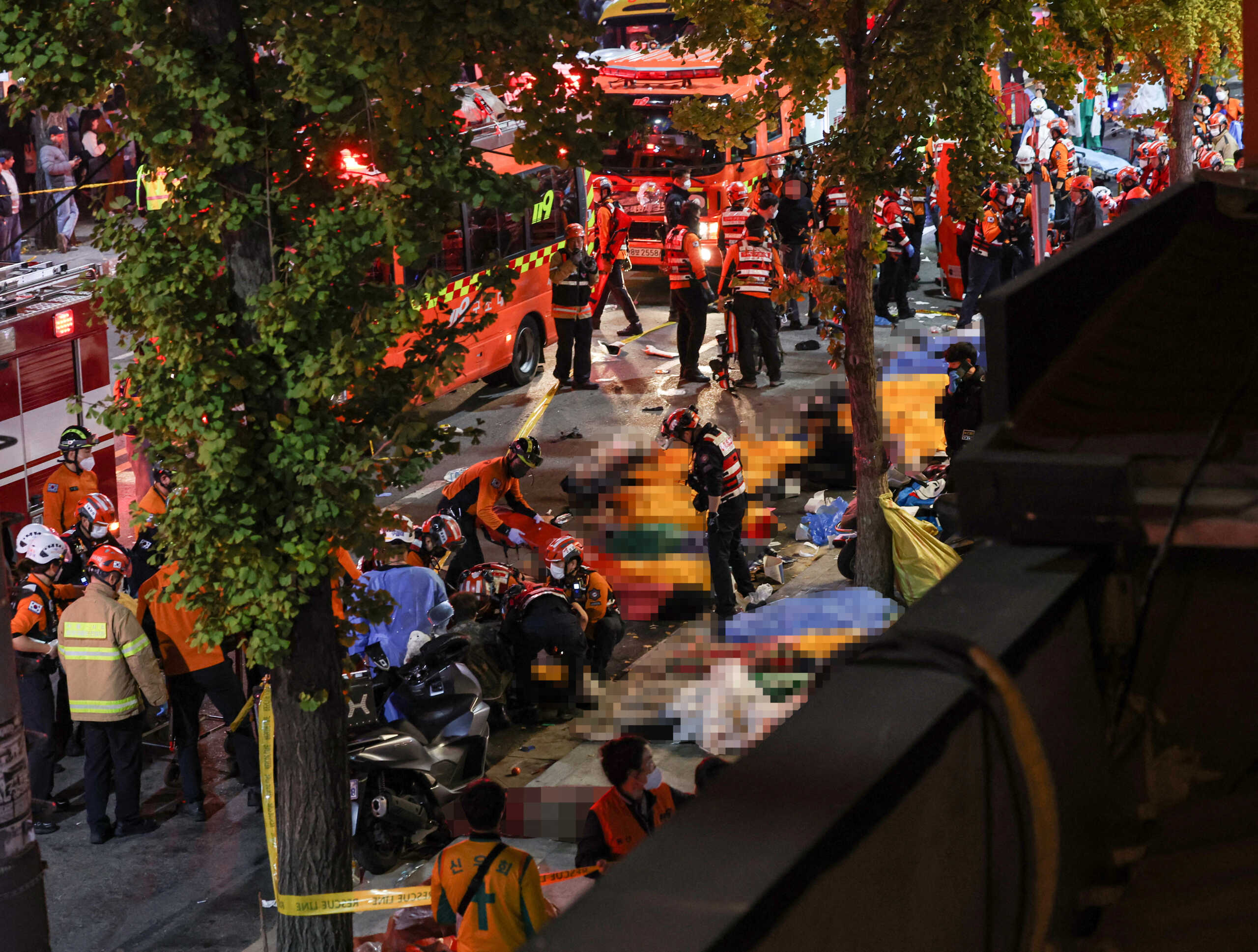 Rescue team and firefighters work on the scene where dozens of people were injured in a stampede during Halloween festival in Seoul, South Korea, October 30, 2022.    Yonhap via REUTERS   ATTENTION EDITORS - THIS IMAGE HAS BEEN SUPPLIED BY A THIRD PARTY. SOUTH KOREA OUT. NO RESALES. NO ARCHIVE. THE IMAGE HAS BEEN PIXELATED AT SOURCE.