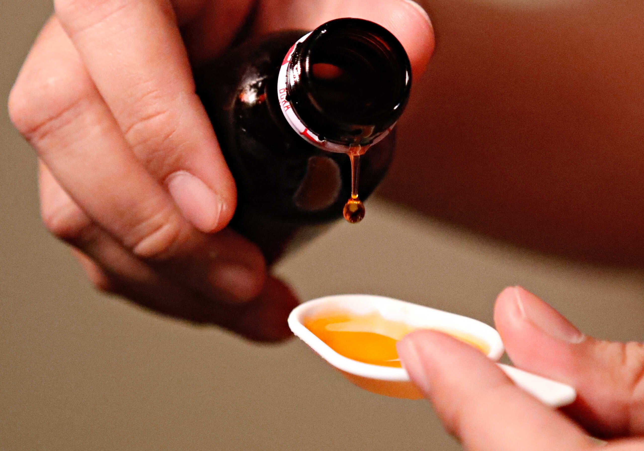 A cough medication is poured in this picture illustration taken October 19, 2022. REUTERS