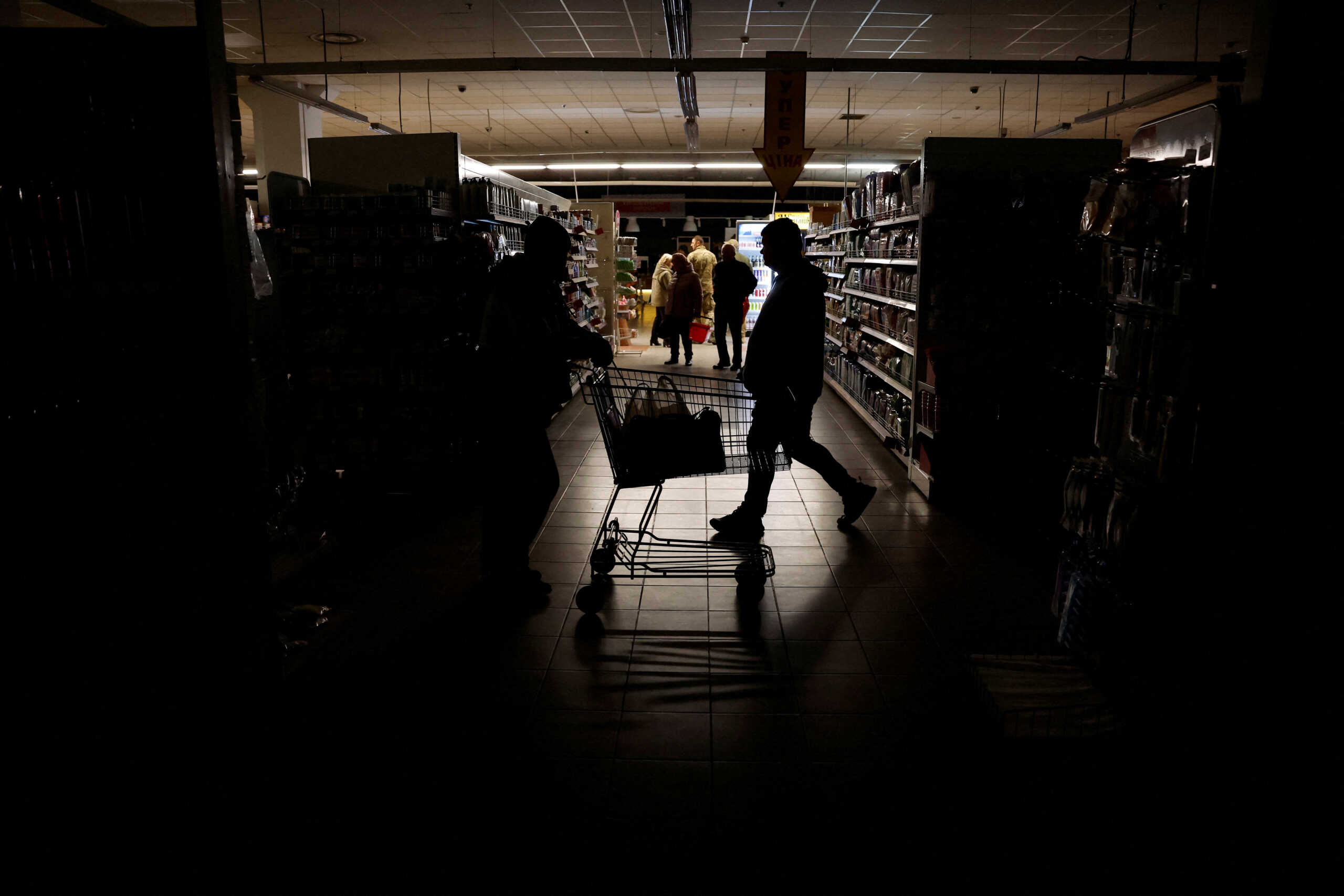 People shop in a supermarket as Kharkiv suffers an electricity outage, amid Russia's attack on Ukraine, in Kharkiv, Ukraine, October 17, 2022. REUTERS