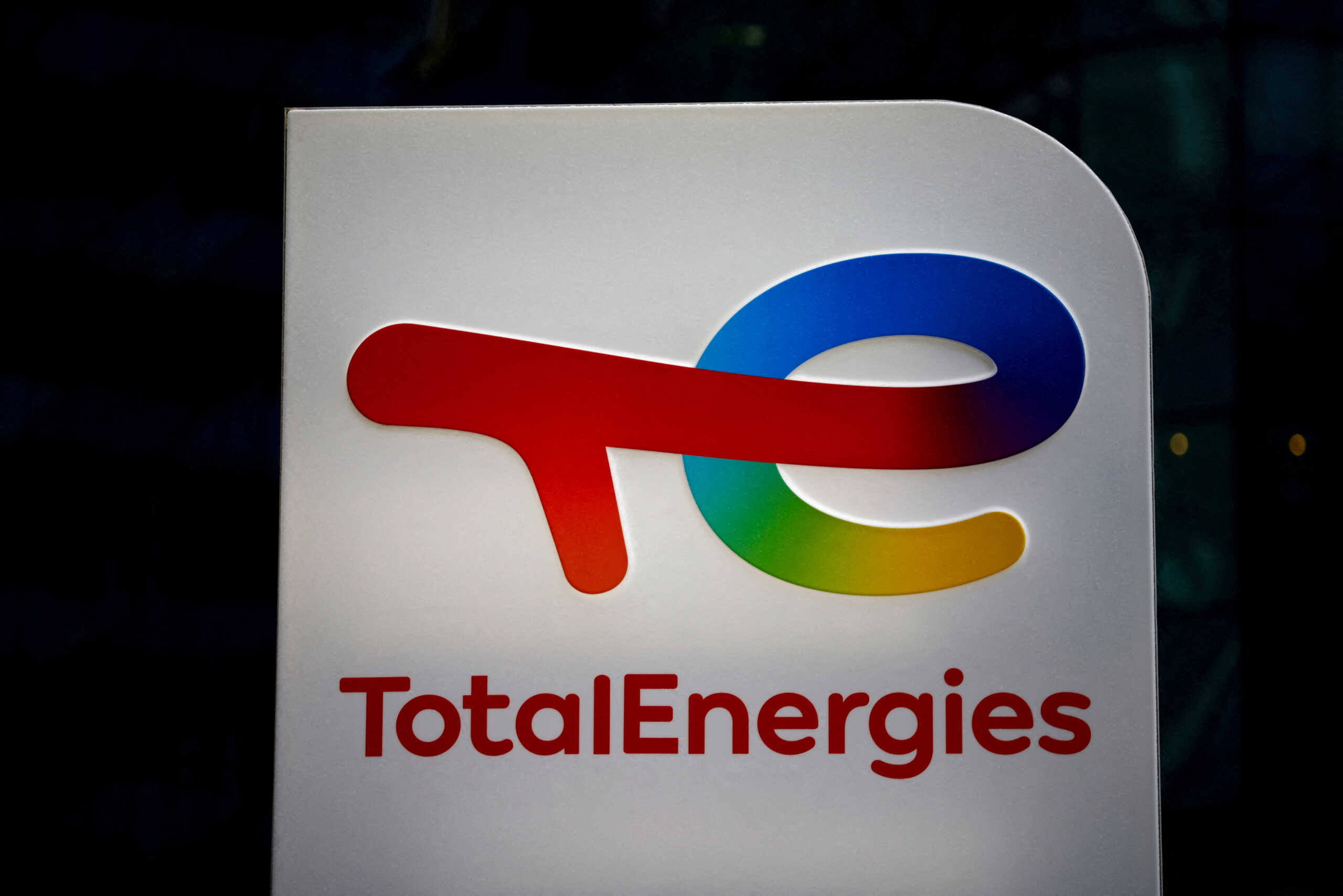 FILE PHOTO: The logo of French oil and gas company TotalEnergies is pictured at an electric car charging station and petrol station at the financial and business district of La Defense in Courbevoie near Paris, France, June 22, 2021. REUTERS
