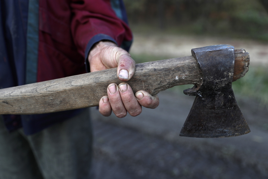 epa10218344 Ukrainian man holds an axe for cutting wood as part of his preparations for winter  in Izyum, Kharkiv region, Ukraine, 01 October 2022. People in Ukraine are preparing for the winter season amid uncertainty over energy supplies. The Ukrainian army pushed Russian troops from occupied territory in the northeast of the country in a counterattack. Kharkiv and surrounding areas have been the target of heavy shelling since February 2022, when Russian troops entered Ukraine starting a conflict that has provoked destruction and a humanitarian crisis.  EPA