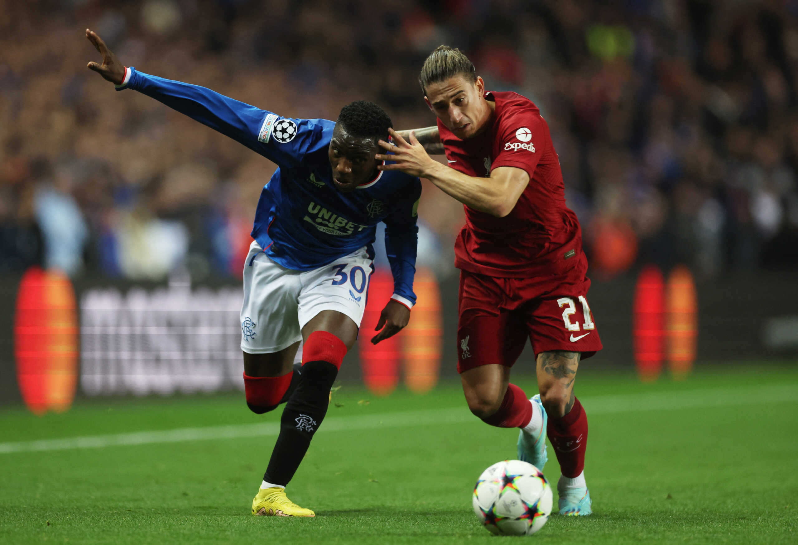 Soccer Football - Champions League - Group A - Rangers v Liverpool - Ibrox Stadium, Glasgow, Scotland, Britain - October 12, 2022  Liverpool's Kostas Tsimikas in action with Rangers' Fashion Sakala Action Images via Reuters