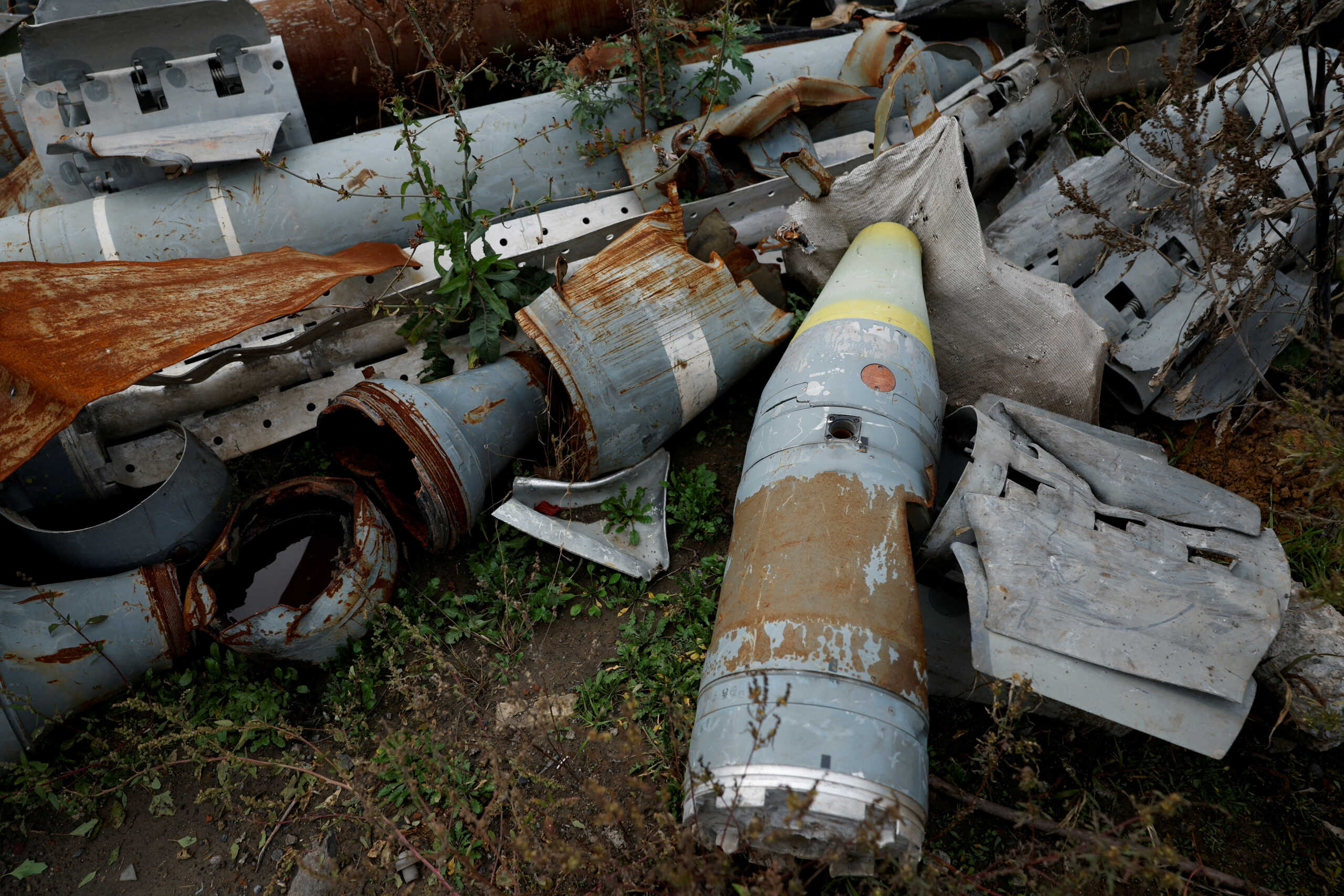 Ukrainian military displays pieces of rockets used by the Russian army, that a Ukrainian munitions expert said did not explode on impact, in the region of Kharkiv, Ukraine, October 21, 2022. REUTERS