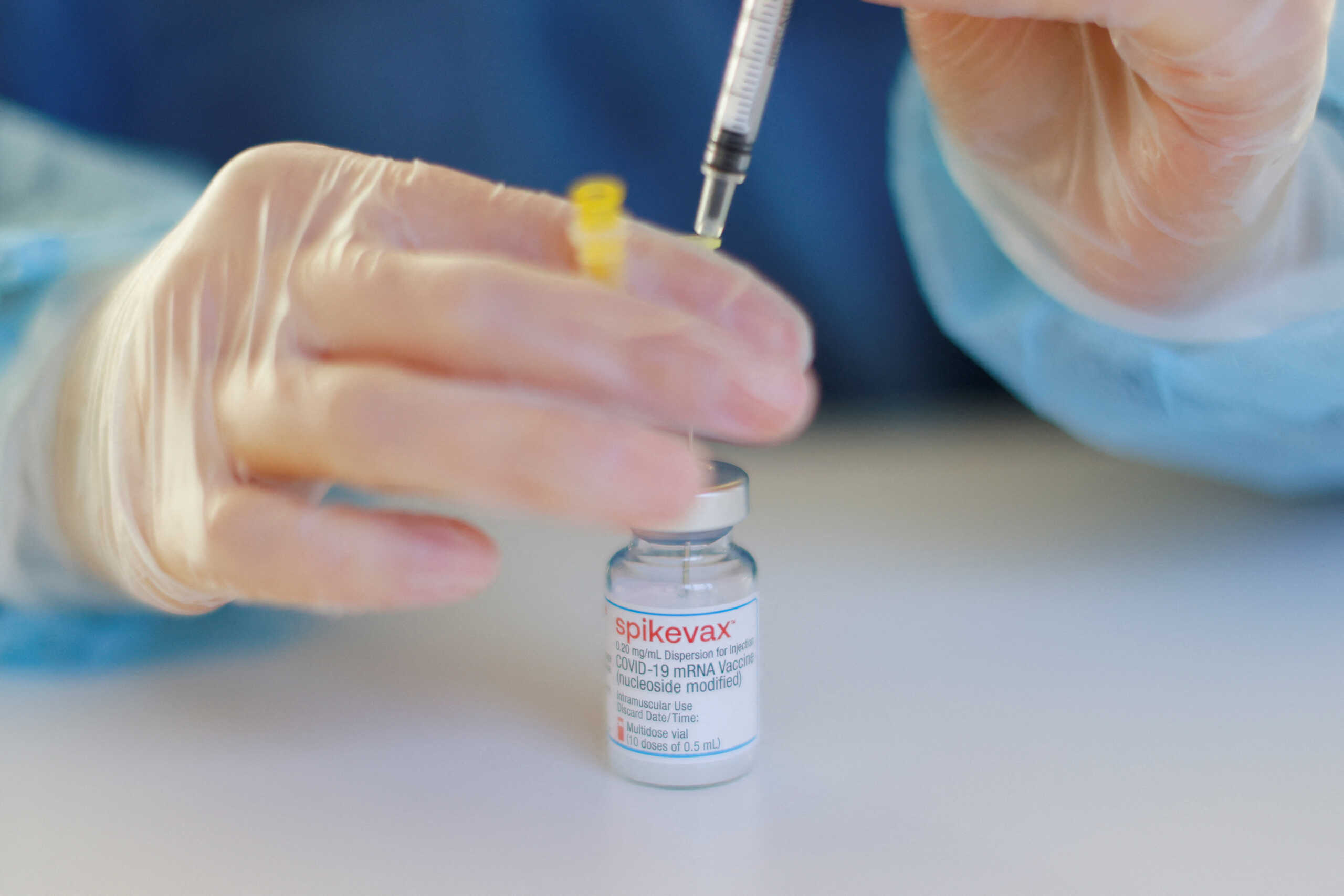 FILE PHOTO: A nurse prepares a booster dose of the Moderna COVID-19 vaccine, Spikevax, against the coronavirus disease at a vaccination centre in Berlin, Germany, January 1, 2022. REUTERS