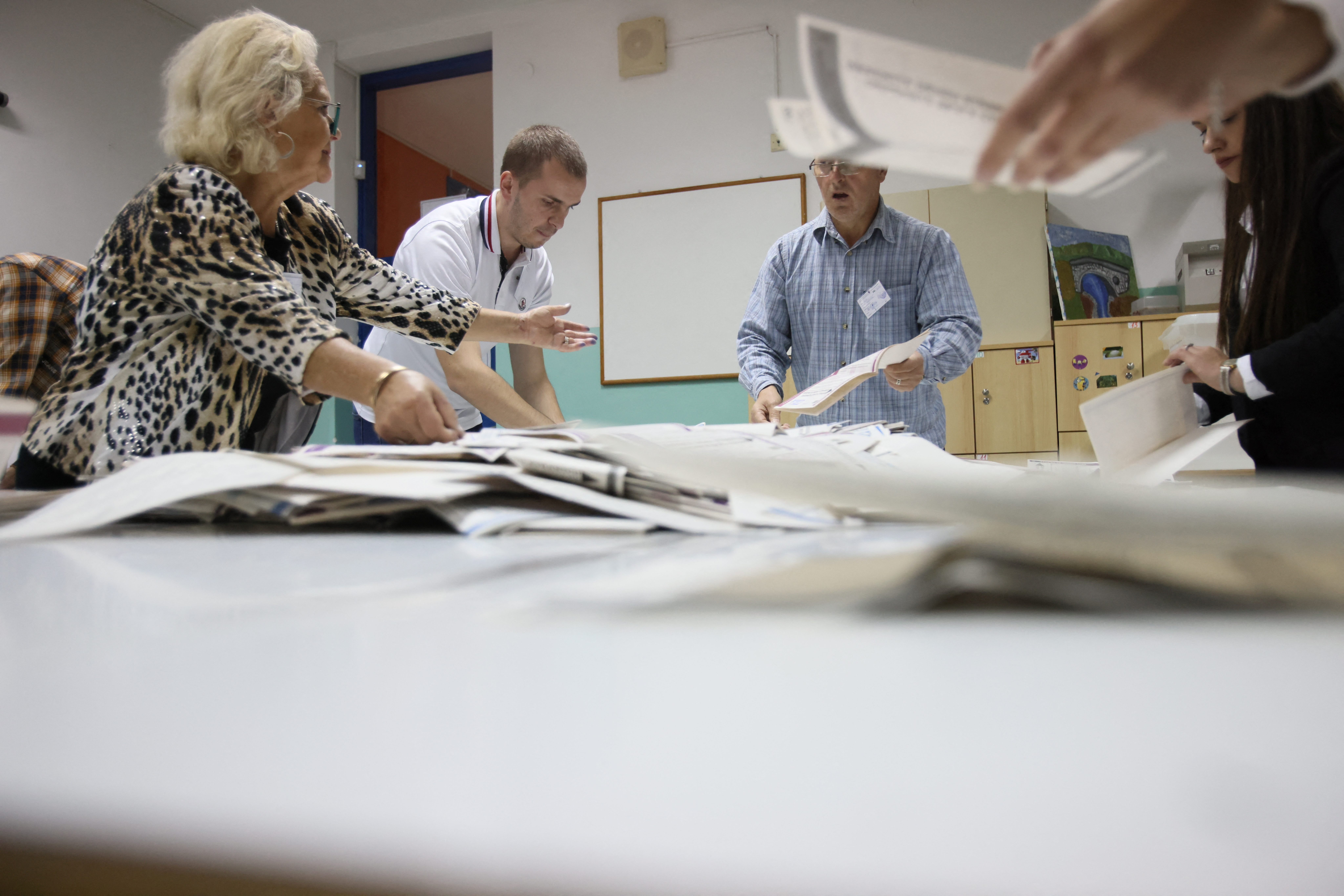 Election Commission officials count votes after presidential and parliamentary elections at a polling station in a school in Sarajevo, Bosnia and Herzegovina October 2, 2022. REUTERS