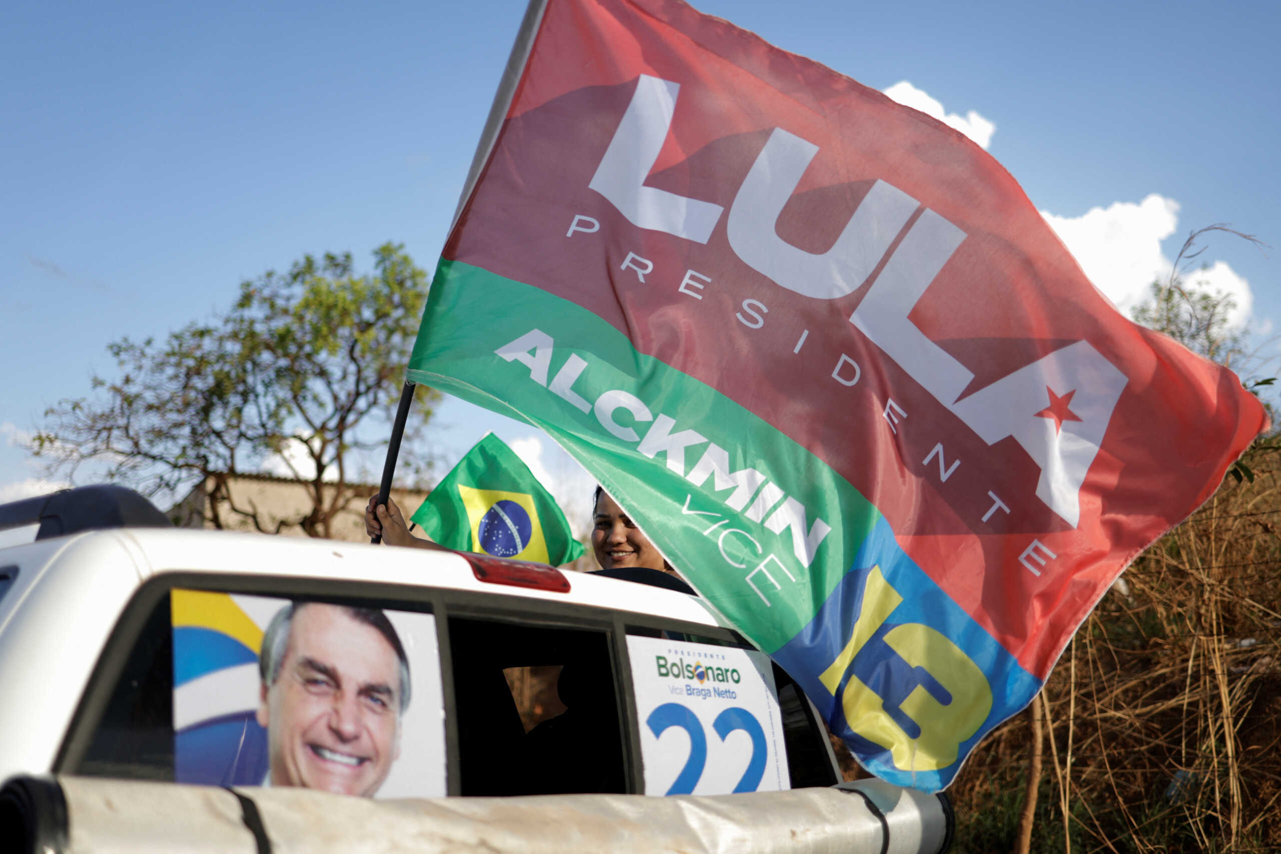 A supporter of Brazil's former President and presidential candidate Luiz Inacio Lula da Silva holds a flag during a motorcade to support local candidate in Brasilia, Brazil October 1, 2022. REUTERS