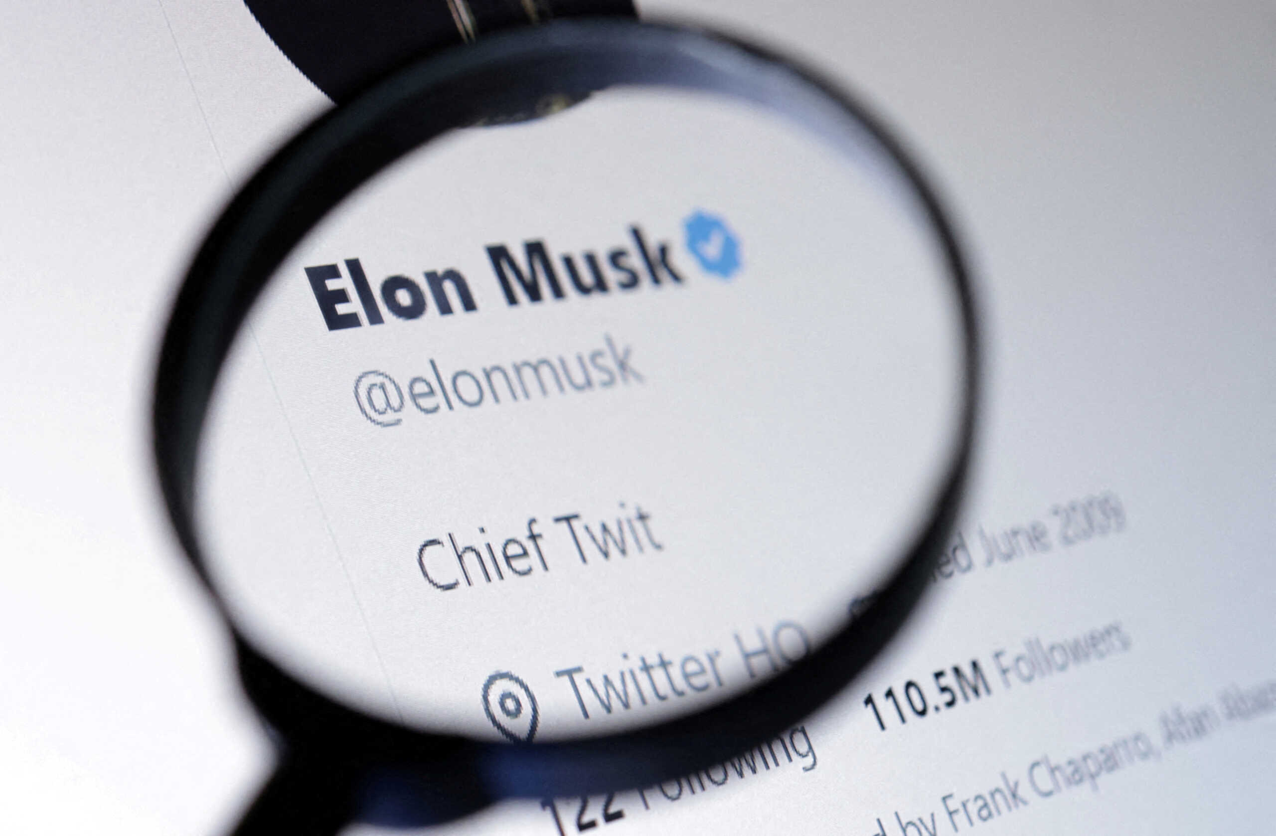 FILE PHOTO: Elon Musk's Twitter account is seen through a magnifier in this illustration taken October 28, 2022. REUTERS