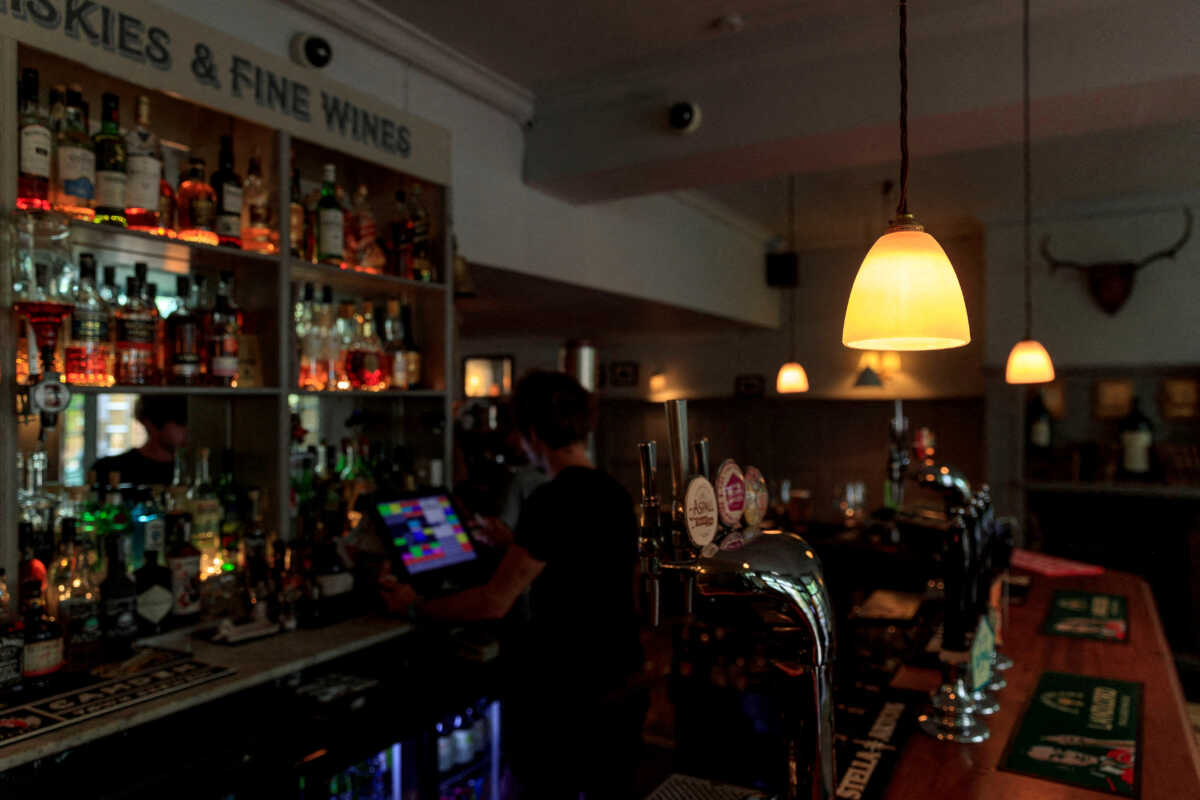 FILE PHOTO: A staff member works at the Red Lion and Sun in London, Britain, August 30, 2022. REUTERS