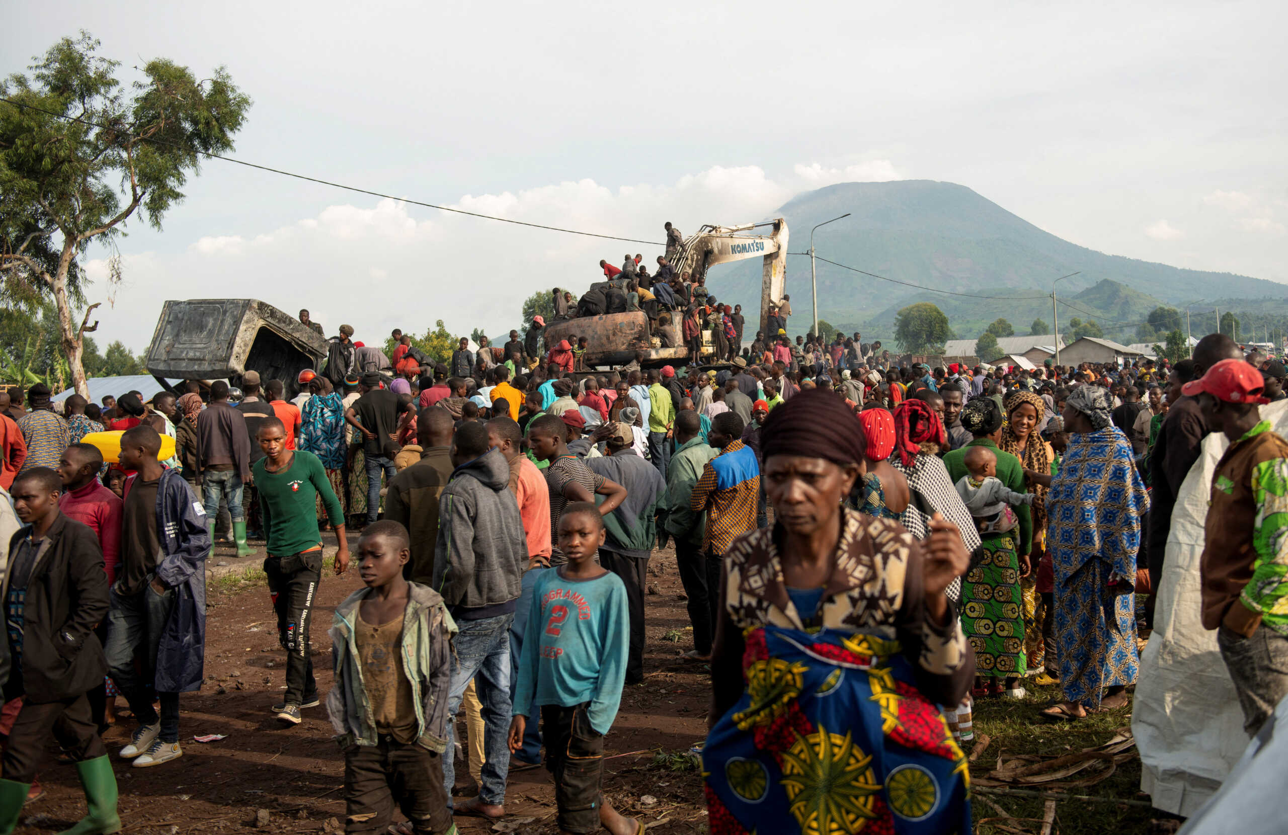 Civilians gather atop a wreckage of a United Nations peacekeeping vehicle, part of the convoy that was attacked when it stopped at an army checkpoint near an internally displaced persons site in Kanyarutshinya, near the city of Goma in the North Kivu province of the Democratic Republic of Congo, November 2, 2022. REUTERS