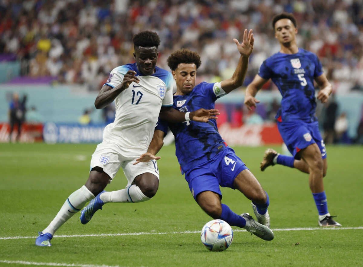 Soccer Football - FIFA World Cup Qatar 2022 - Group B - England v United States - Al Bayt Stadium, Al Khor, Qatar - November 25, 2022 England's Bukayo Saka in action with Tyler Adams of the U.S. REUTERS