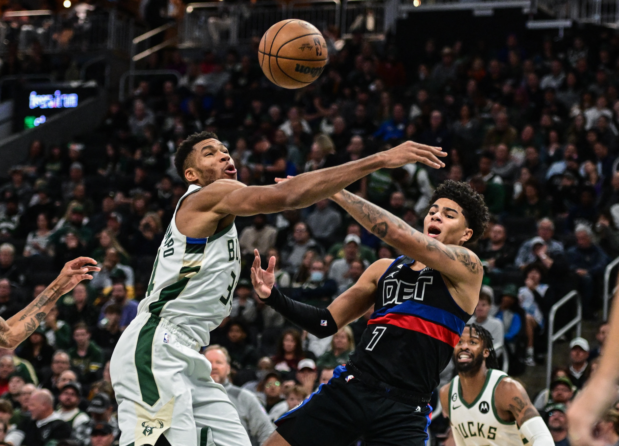 Nov 2, 2022; Milwaukee, Wisconsin, USA;  Milwaukee Bucks forward Giannis Antetokounmpo (34) and Detroit Pistons guard Killian Hayes (7) reach for a rebound in the third quarter at Fiserv Forum. Mandatory Credit: Benny Sieu-USA TODAY Sports