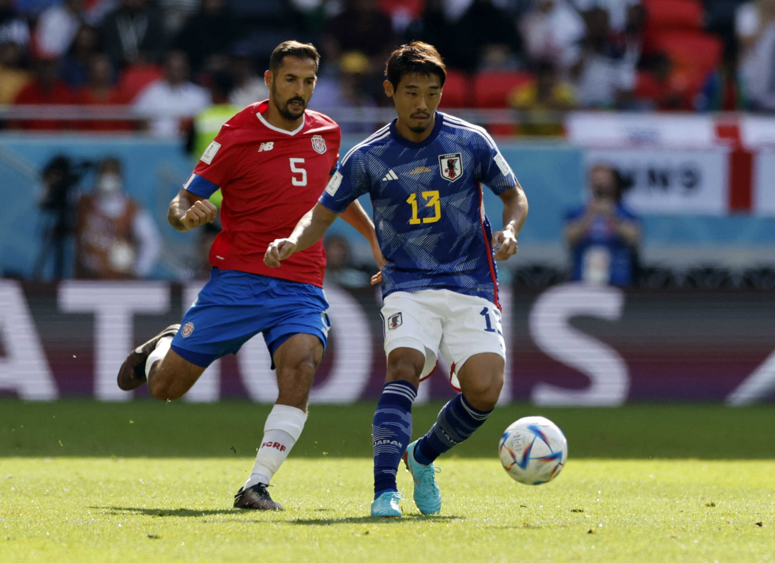 Soccer Football - FIFA World Cup Qatar 2022 - Group E - Japan v Costa Rica - Ahmad Bin Ali Stadium, Al Rayyan, Qatar - November 27, 2022 Japan's Hidemasa Morita in action with Costa Rica's Celso Borges REUTERS