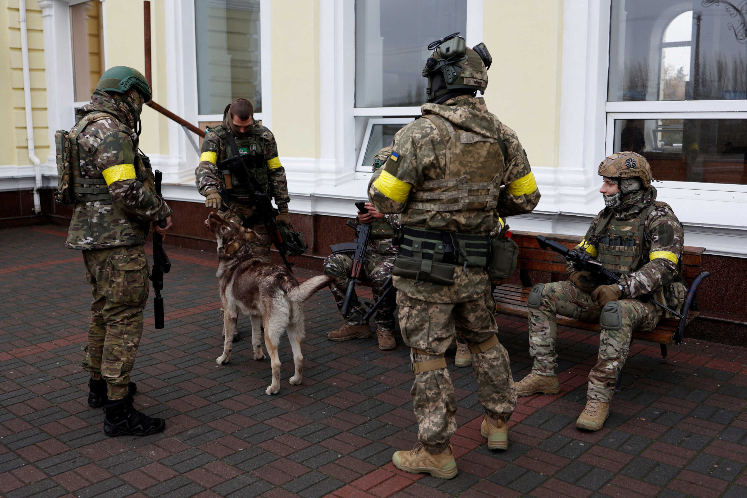 Ukrainian service members gather at the main train station before the arrival of the first train from Kyiv to Kherson after Russia's military retreat from the city, in Kherson, Ukraine November 19, 2022. REUTERS