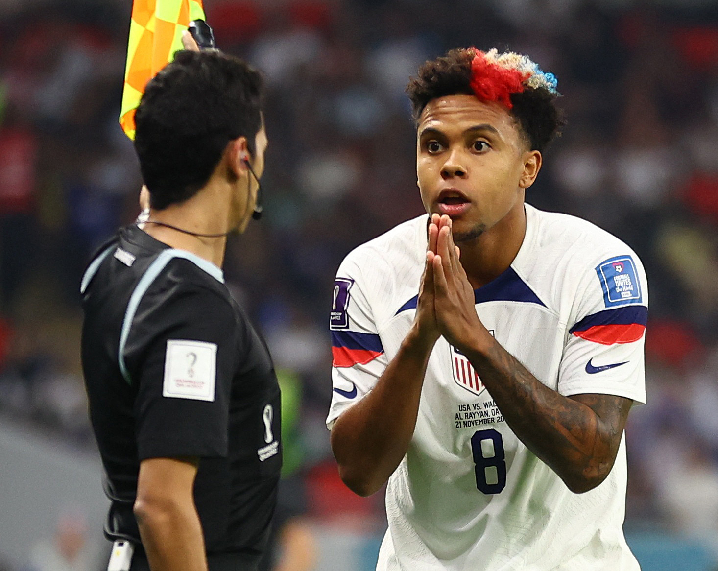 Soccer Football - FIFA World Cup Qatar 2022 - Group B - United States v Wales - Ahmad Bin Ali Stadium, Al Rayyan, Qatar - November 21, 2022  Weston McKennie of the U.S. remonstrates with the assistant referee REUTERS