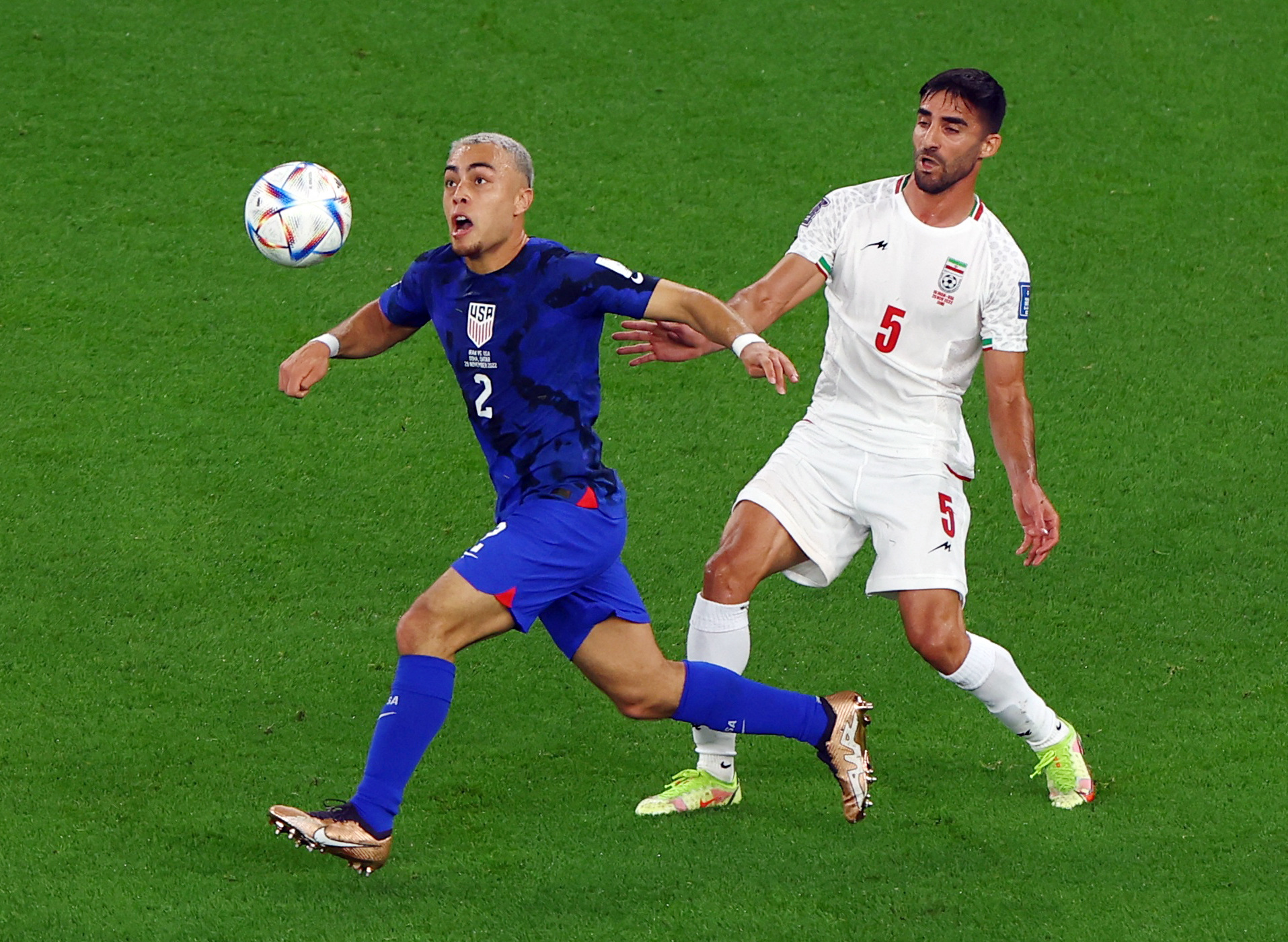 Soccer Football - FIFA World Cup Qatar 2022 - Group B - Iran v United States - Al Thumama Stadium, Doha, Qatar - November 29, 2022 Sergino Dest of the U.S. in action with Iran's Milad Mohammadi REUTERS