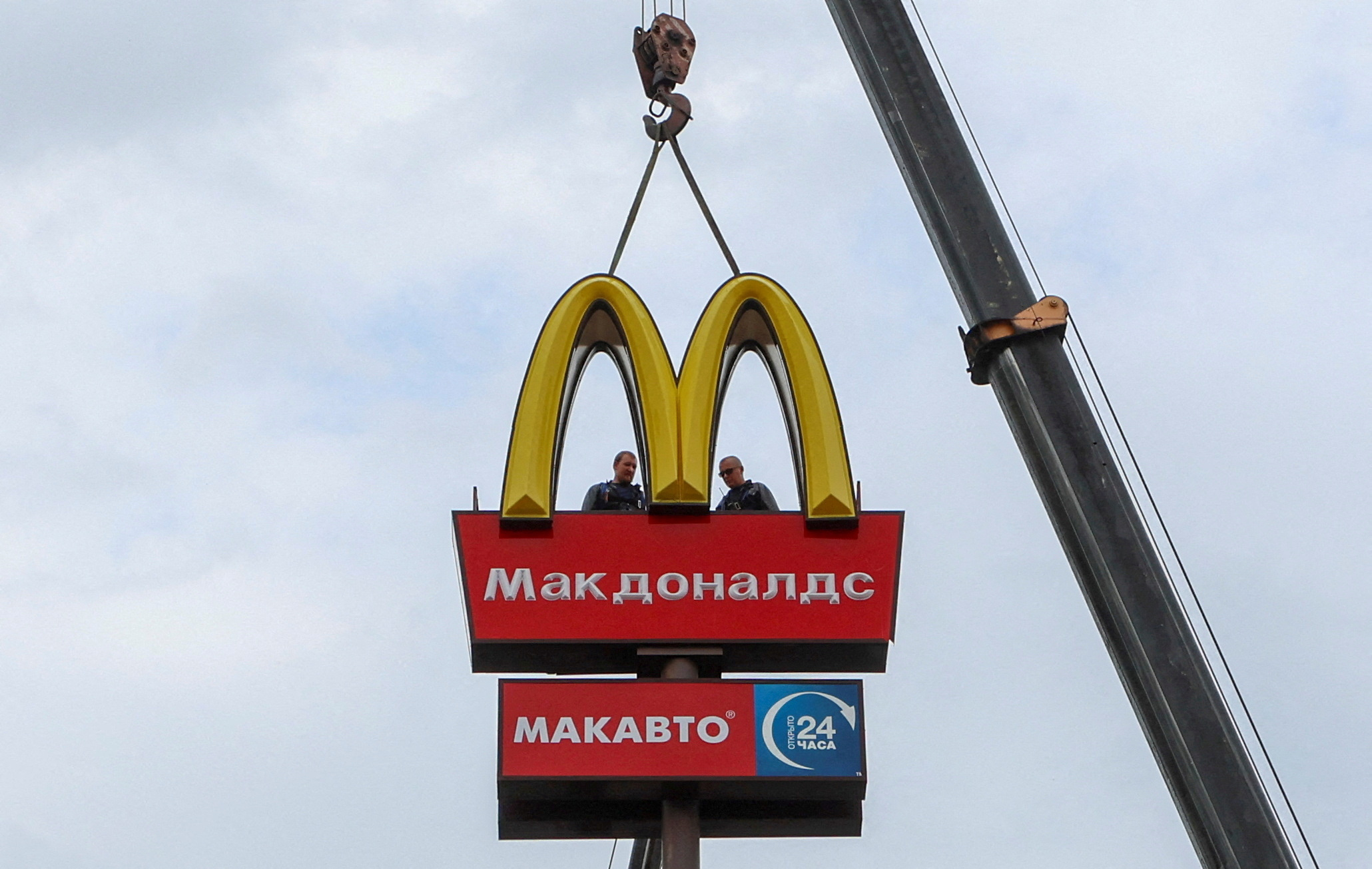 FILE PHOTO: Workers use a crane to dismantle the McDonald's Golden Arches while removing the logo signage from a drive-through restaurant of McDonald's in the town of Kingisepp in the Leningrad region, Russia June 8, 2022. REUTERS