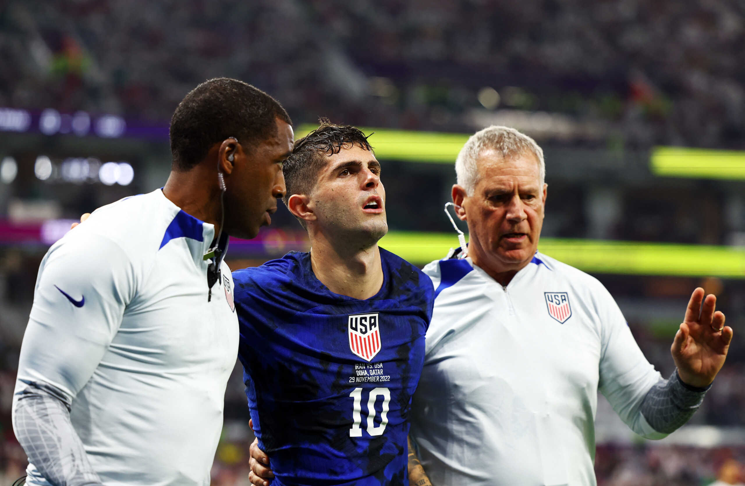 Soccer Football - FIFA World Cup Qatar 2022 - Group B - Iran v United States - Al Thumama Stadium, Doha, Qatar - November 29, 2022 Christian Pulisic of the U.S. receives medical attention after colliding with Iran's Alireza Beiranvand after he scores their first goal REUTERS