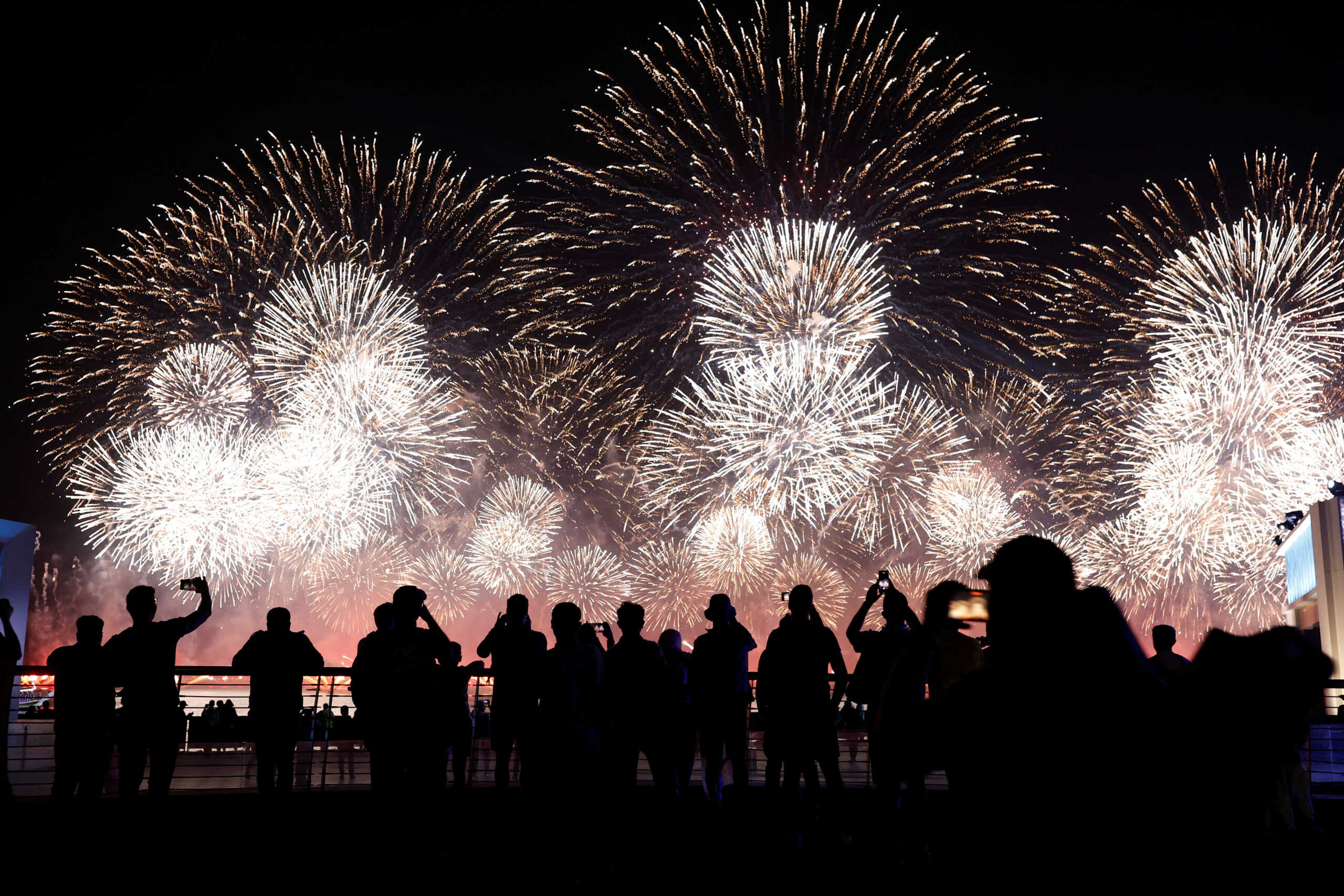 Soccer Football - FIFA World Cup Qatar 2022 - Doha, Qatar - November 20, 2022 People watch fireworks at Doha Corniche REUTERS