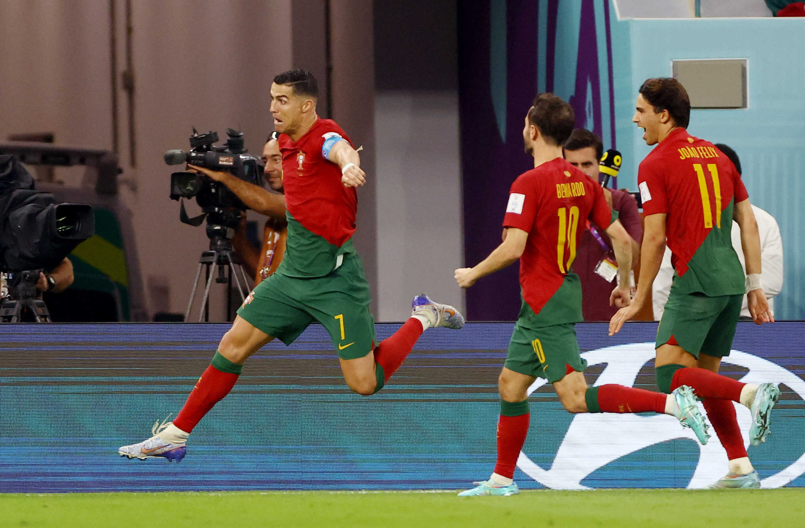 Soccer Football - FIFA World Cup Qatar 2022 - Group H - Portugal v Ghana - Stadium 974, Doha, Qatar - November 24, 2022  Portugal's Cristiano Ronaldo celebrates scoring their first goal with Joao Felix and Bernardo Silva REUTERS
