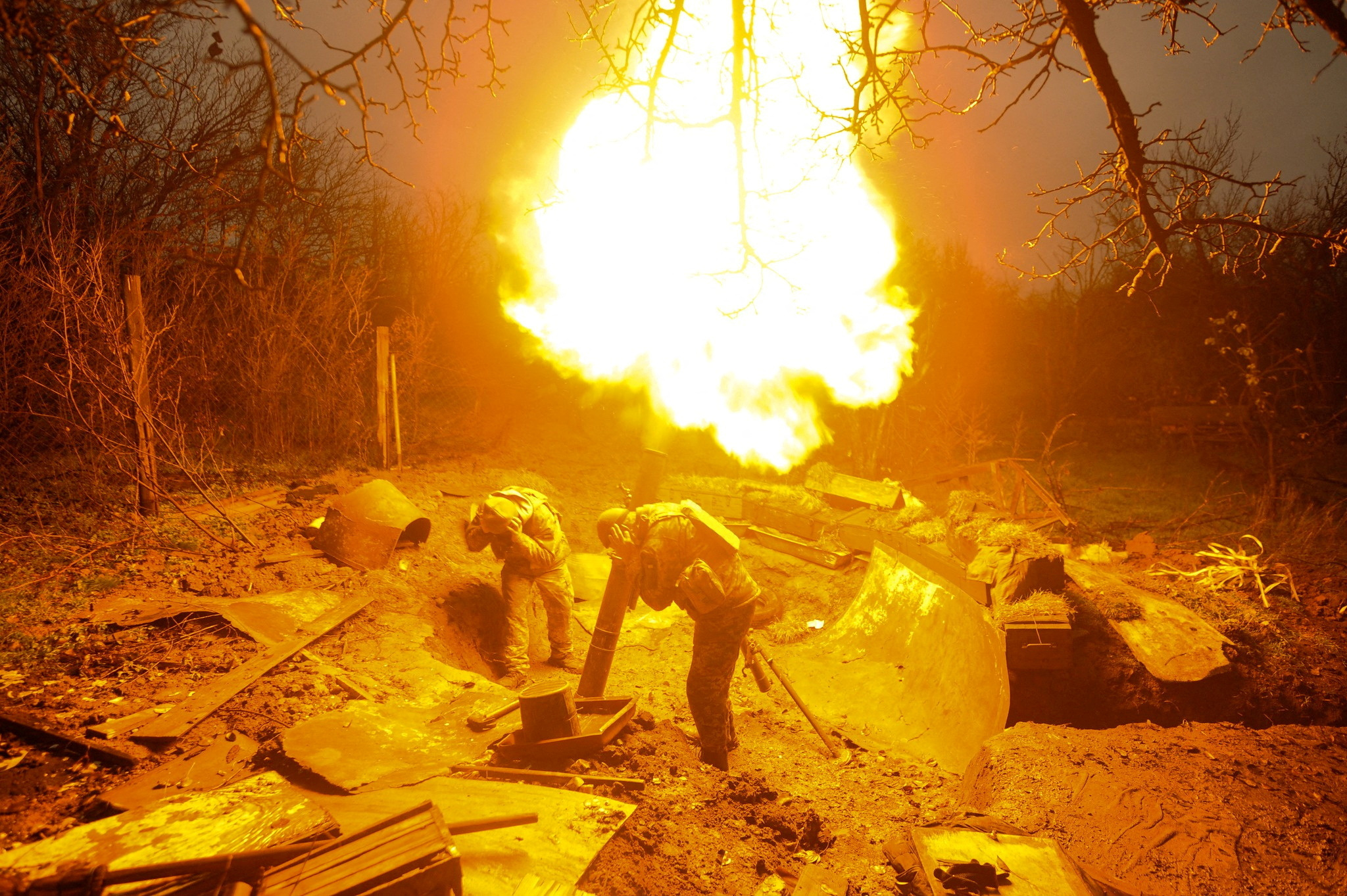 Ukrainian servicemen fire a mortar on a front line, as Russia's attack on Ukraine continues, in Donetsk region, Ukraine, in this handout image released November 20, 2022.  Iryna Rybakova