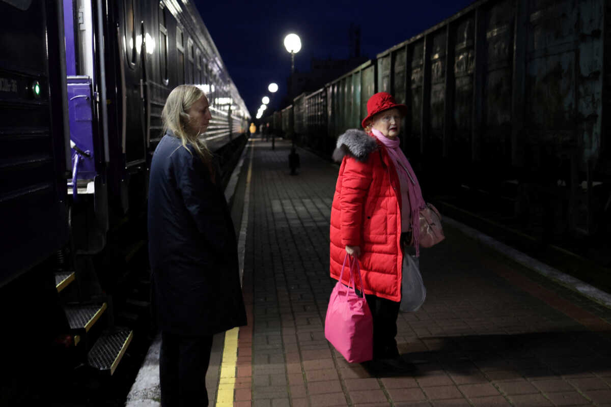 A woman stands at the platform before getting on a train bound for Kyiv, after Russia's military retreat from Kherson, at the central train station in Kherson, Ukraine November 23, 2022. REUTERS