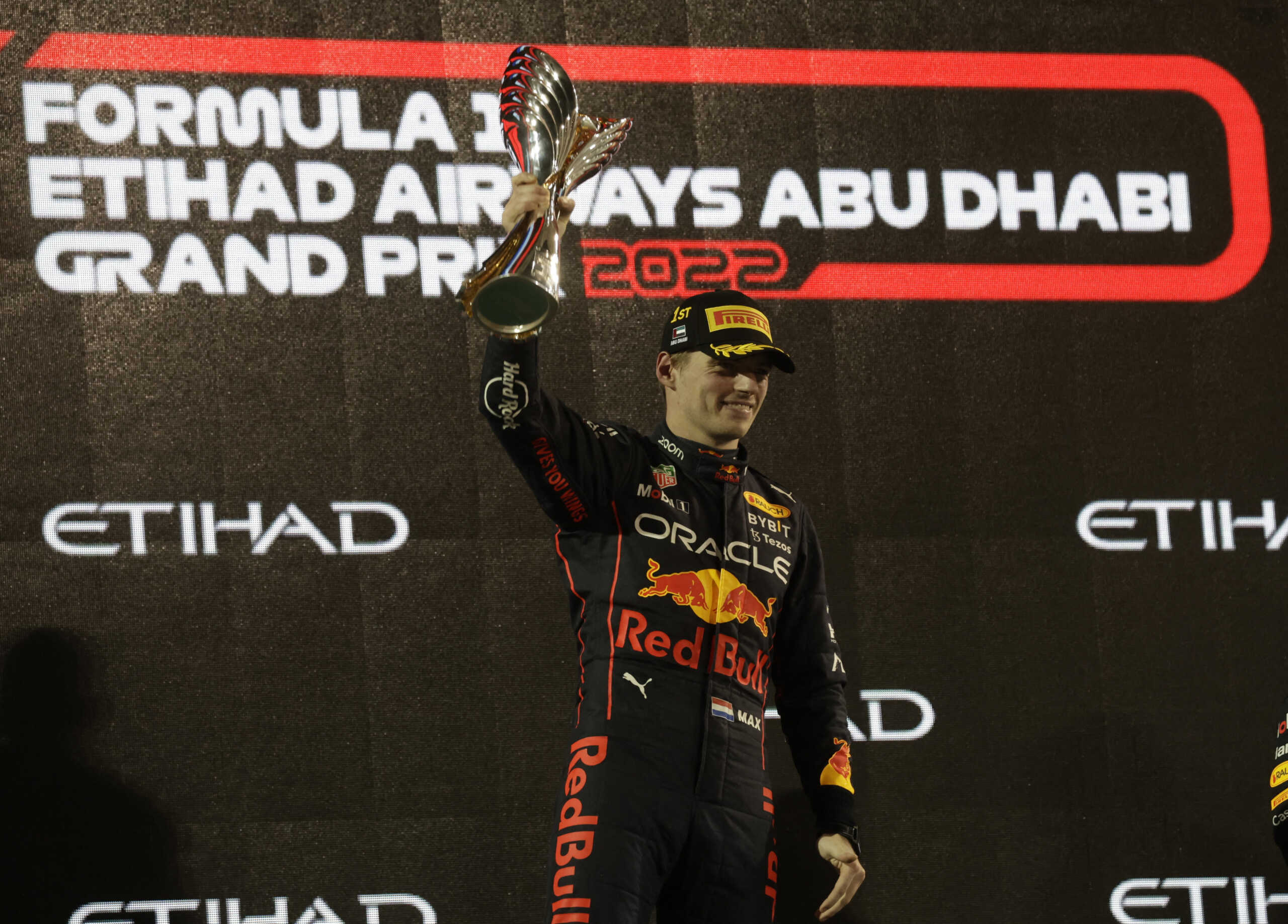 Formula One F1 - Abu Dhabi Grand Prix - Yas Marina Circuit, Abu Dhabi, United Arab Emirates - November 20, 2022 Red Bull's Max Verstappen celebrates on the podium with the trophy after winning the Abu Dhabi Grand Prix REUTERS