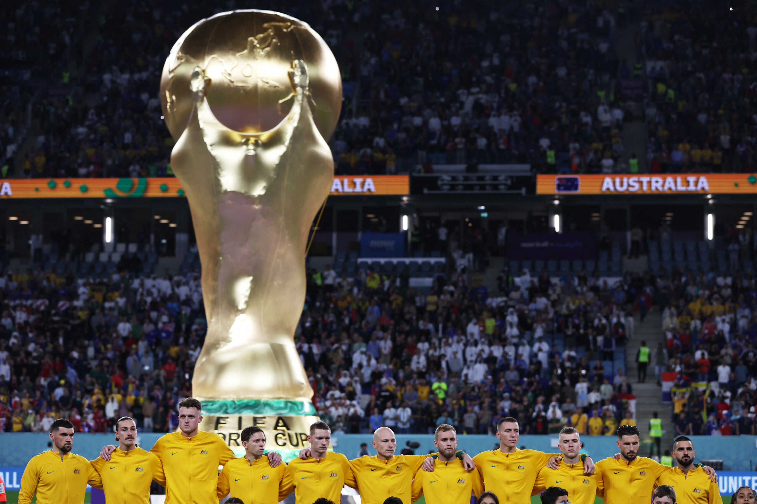 Soccer Football - FIFA World Cup Qatar 2022 - Group D - France v Australia - Al Janoub Stadium, Al Wakrah, Qatar - November 22, 2022  General view of a giant replica World Cup trophy on the pitch as Australia players line up before the match REUTERS