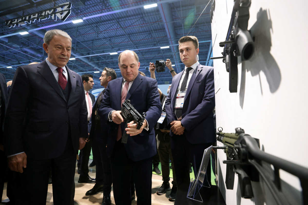 British Defence Minister Ben Wallace holds a submachine gun as he meets Saha Expo Defence and Aerospace Exhibition with his Turkish counterpart Hulusi Akar in Istanbul, Turkey, October 26, 2022. Defence Ministry