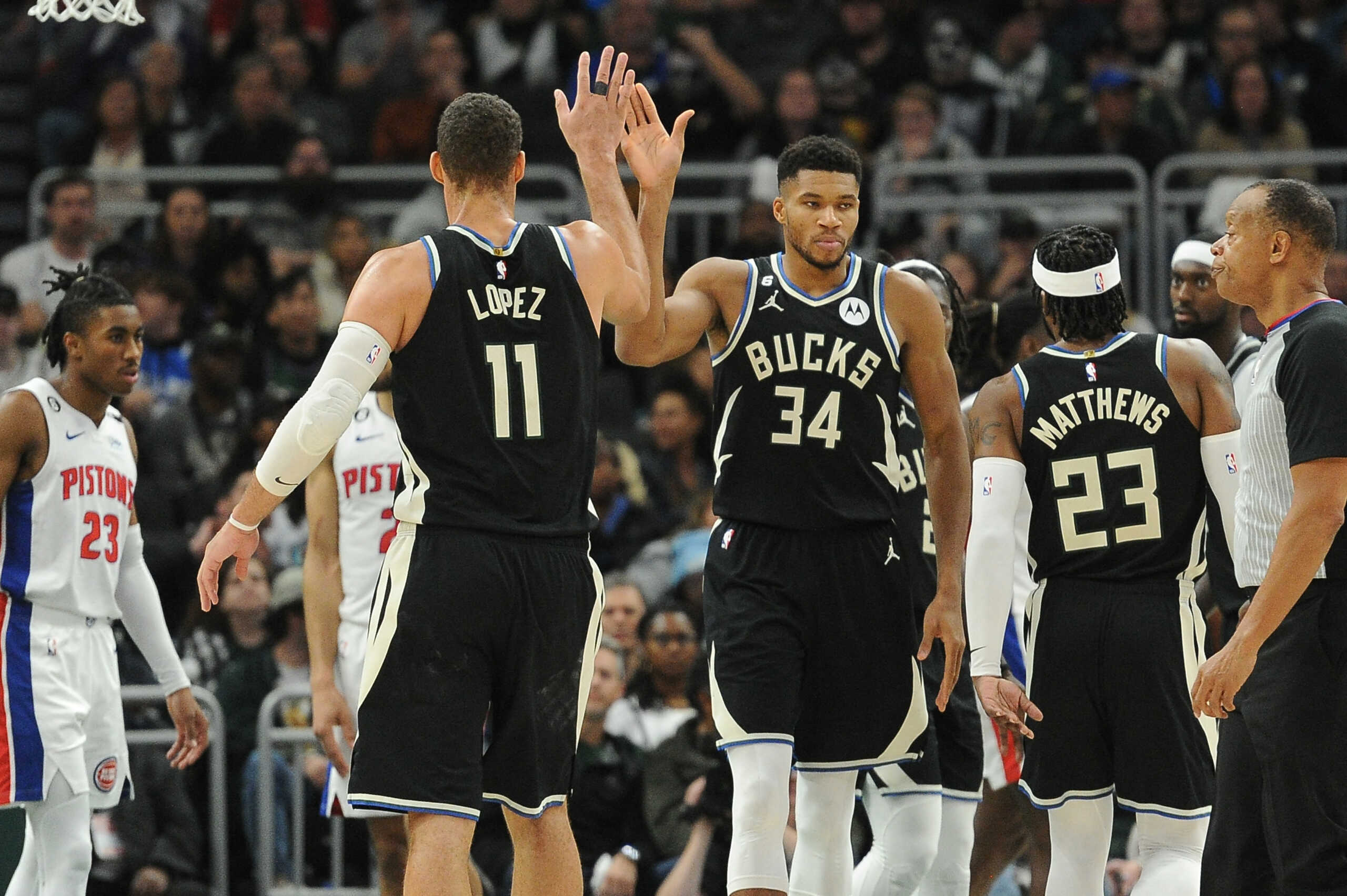 Oct 31, 2022; Milwaukee, Wisconsin, USA; Milwaukee Bucks center Brook Lopez (11) and forward Giannis Antetokounmpo (34) celebrate after Antetokounmpo was fouled driving to the basket against the Detroit Pistons at Fiserv Forum. Mandatory Credit: Michael McLoone-USA TODAY Sports