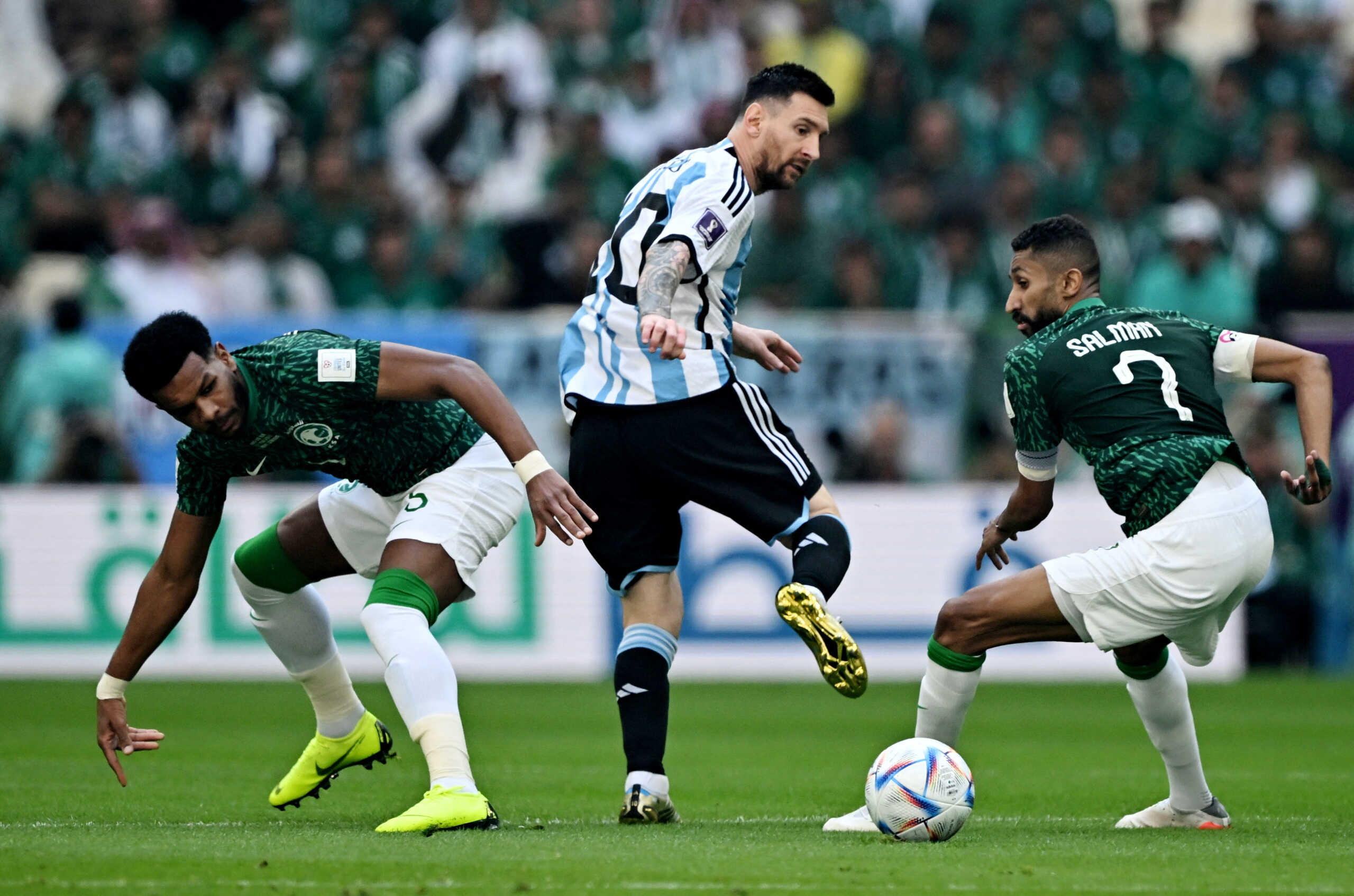 Soccer Football - FIFA World Cup Qatar 2022 - Group C - Argentina v Saudi Arabia - Lusail Stadium, Lusail, Qatar - November 22, 2022  Argentina's Lionel Messi in action with Saudi Arabia's Ali Al Bulayhi and Salman Al-Faraj REUTERS