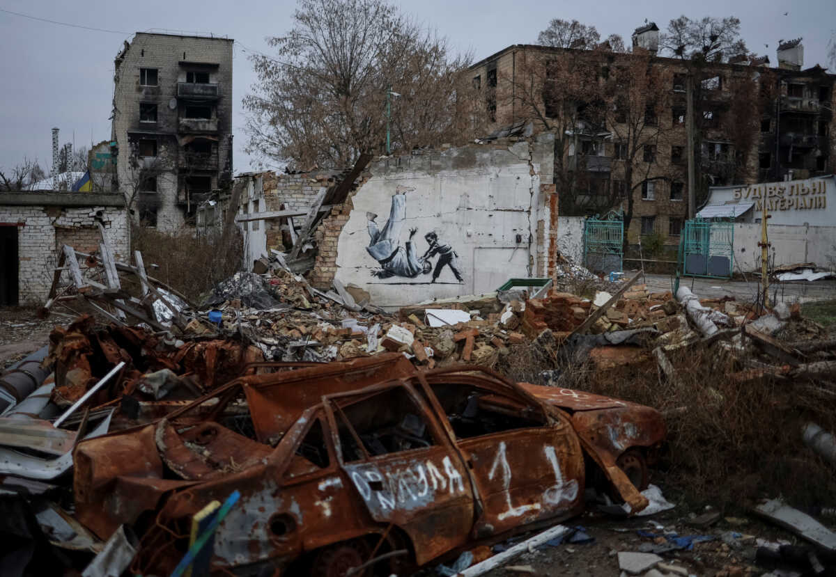 A new graffiti in Banksy's signature style, although not posted by the mercurial artist on social media, is seen at the wall of destroyed building in the Ukrainian town of Borodianka, which had been occupied by Russia until April and heavily damaged by fighting in the early days of Russian invasion, November 12, 2022.  REUTERS