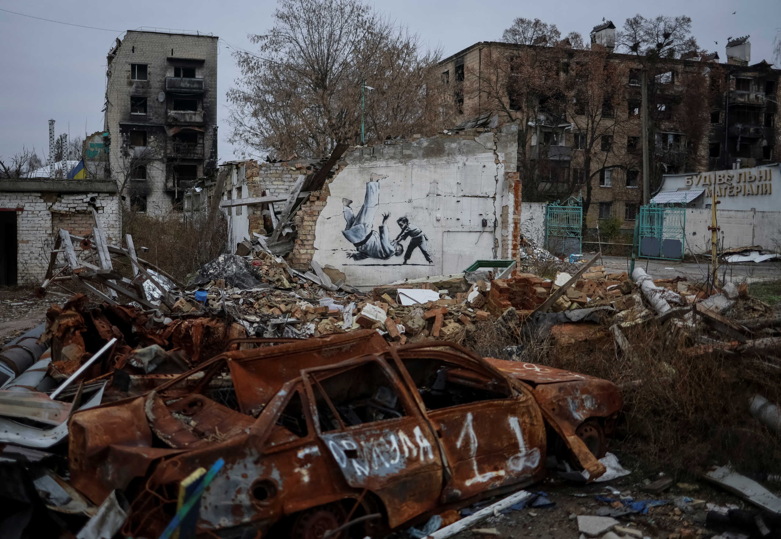 A new graffiti in Banksy's signature style, although not posted by the mercurial artist on social media, is seen at the wall of destroyed building in the Ukrainian town of Borodianka, which had been occupied by Russia until April and heavily damaged by fighting in the early days of Russian invasion, November 12, 2022.  REUTERS