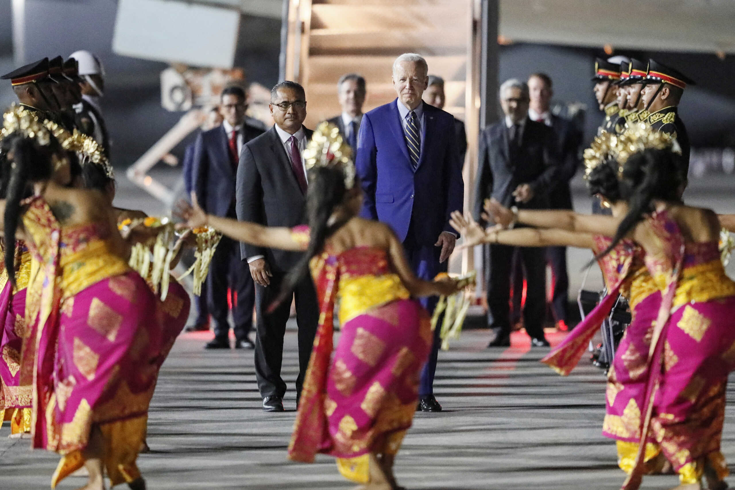 U.S. President Joe Biden looks on as Balinese dancers perform during his arrival for the G20 Summit at Ngurah Rai International airport in Bali, Indonesia, 13 November 2022. Made Nagi