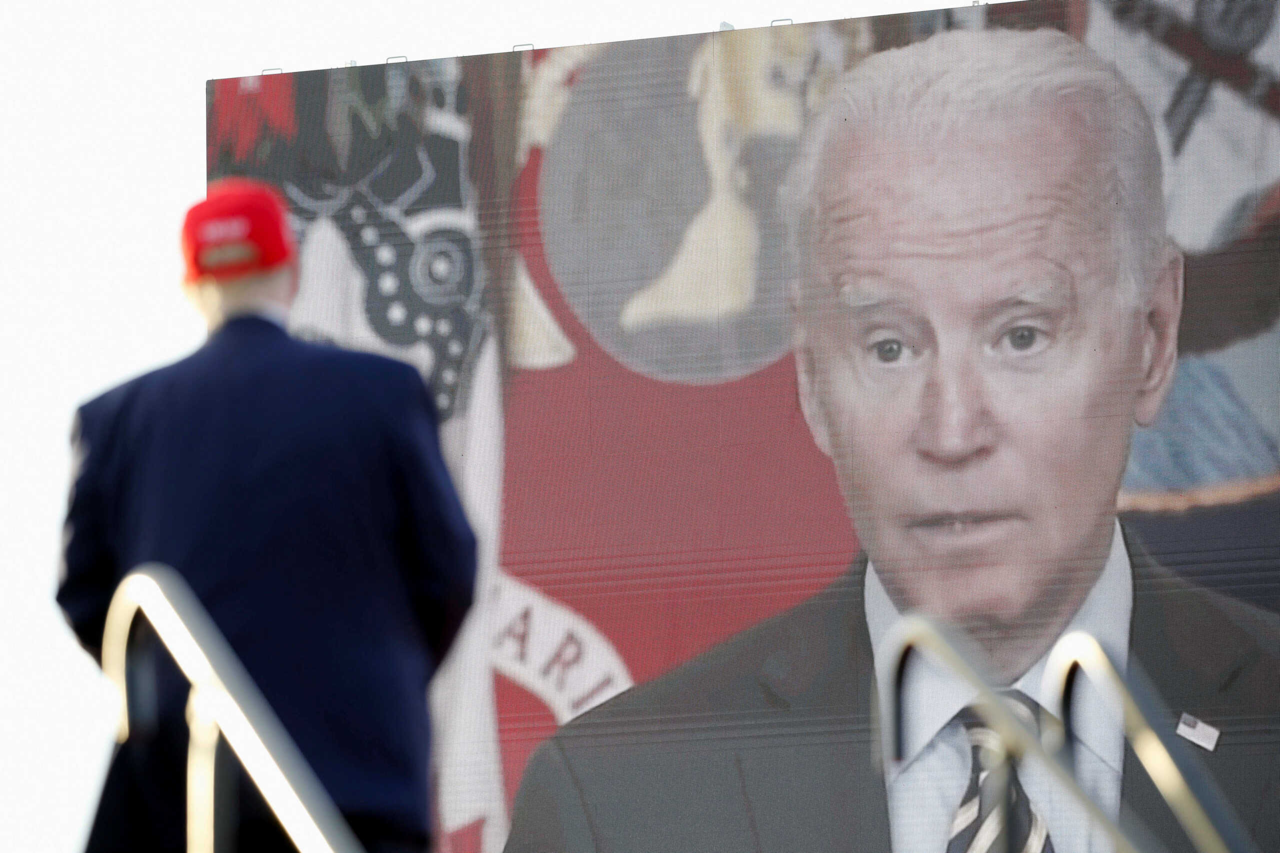 A video of U.S. President Joe Biden is seen on a screen as former U.S. President Donald Trump speaks during a rally ahead of the midterm elections, in Miami, Florida, U.S., November 6, 2022. REUTERS