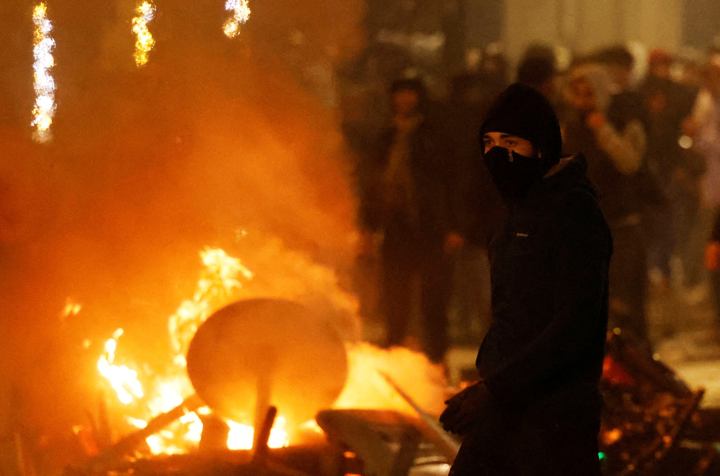 Clashes in Brussels after the World Cup football match between Belgium and Morocco - Brussels, Belgium - November 27, 2022 A man with his face covered is seen during clashes after the World Cup match between Belgium and Morocco REUTERS