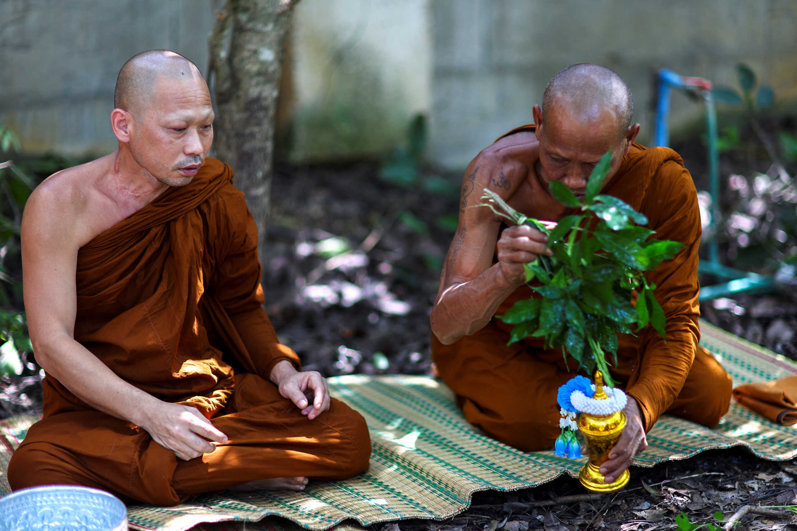 Buddhist monks sprinkle holy water onto the urn of Pattanan Mumklang (known as "Model"), 4, who was killed in a mass shooting at a daycare centre, at a temple near her house in the town of Uthai Sawan, Nong Bua Lamphu province, Thailand, October 12, 2022. Model was among 36 people, 23 of them children, killed by an ex-cop wielding a knife and a gun during an hours-long rampage that only ended when he killed his girlfriend, her son, and himself. The massacre has plunged the tight-knit rural community in northeastern Thailand into shock and left dozens of families grappling with incomprehensible loss.      REUTERS