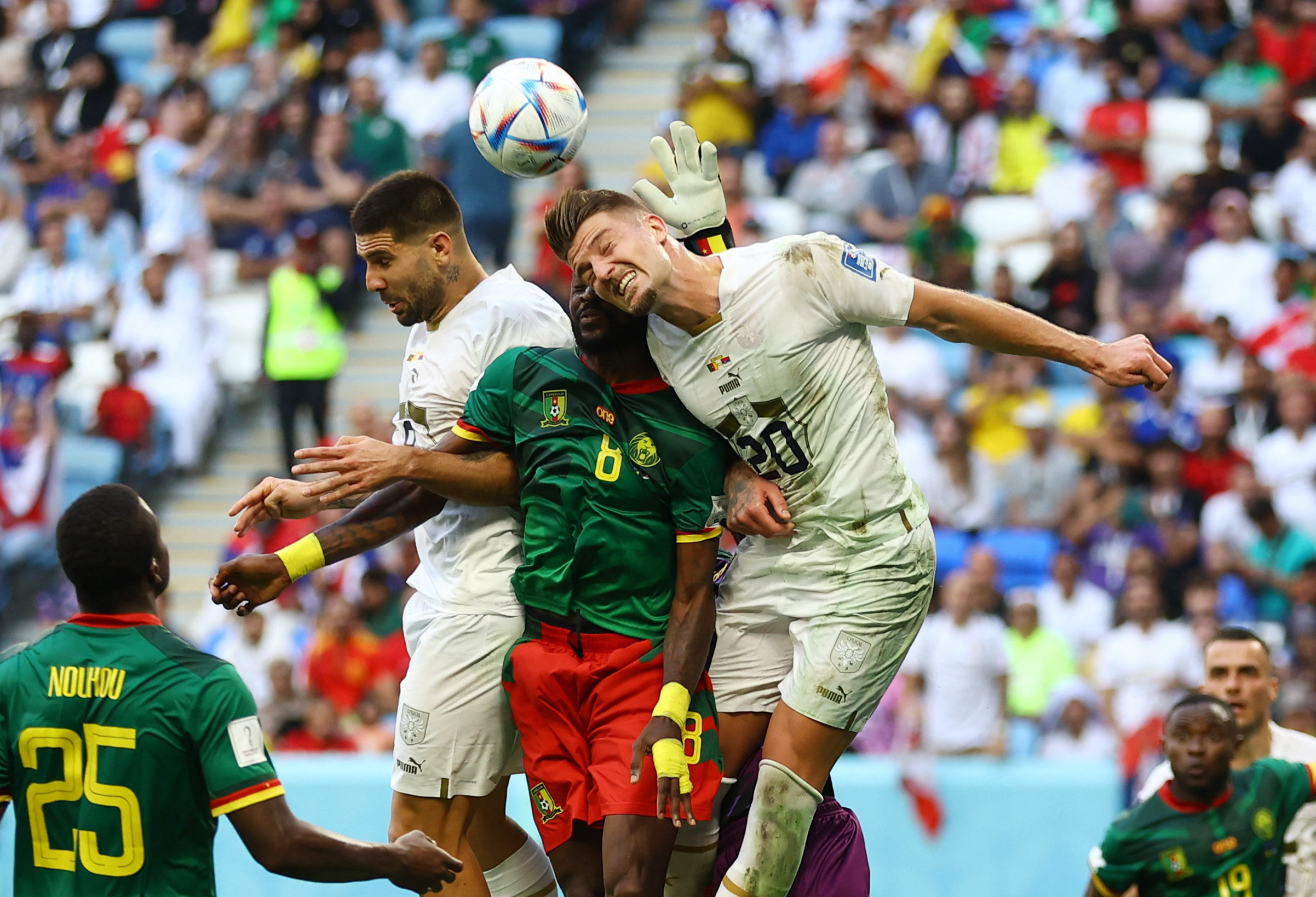 Soccer Football - FIFA World Cup Qatar 2022 - Group G - Cameroon v Serbia - Al Janoub Stadium, Al Wakrah, Qatar - November 28, 2022 Cameroon's Andre-Frank Zambo Anguissa in action with Serbia's Sergej Milinkovic-Savic and Aleksandar Mitrovic REUTERS