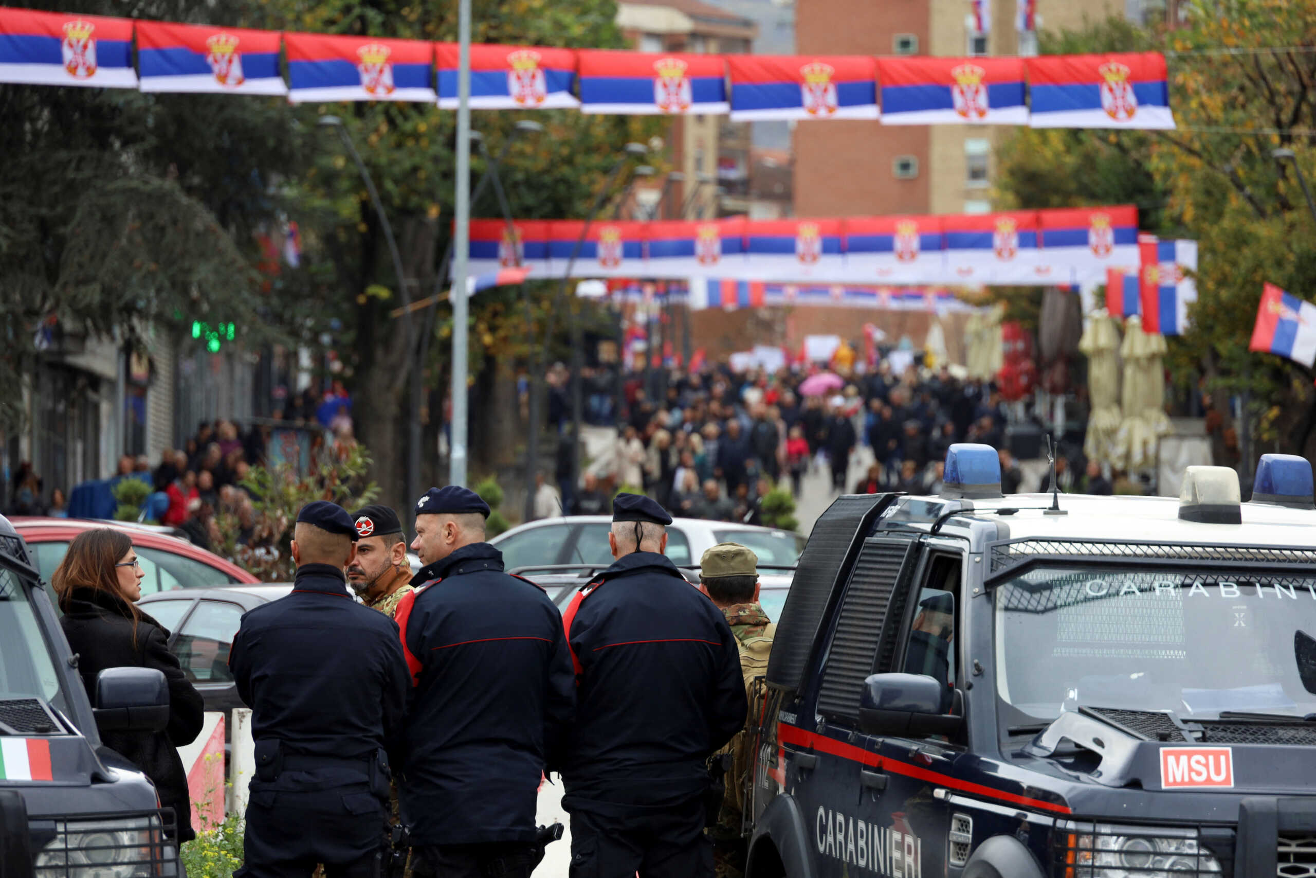 Italian Carabinieri stand guard on a bridge connecting north and south of Mitrovica, as people protest following local Serbs' decision to leave Kosovo institutions, in Kosovo, November 6, 2022. REUTERS