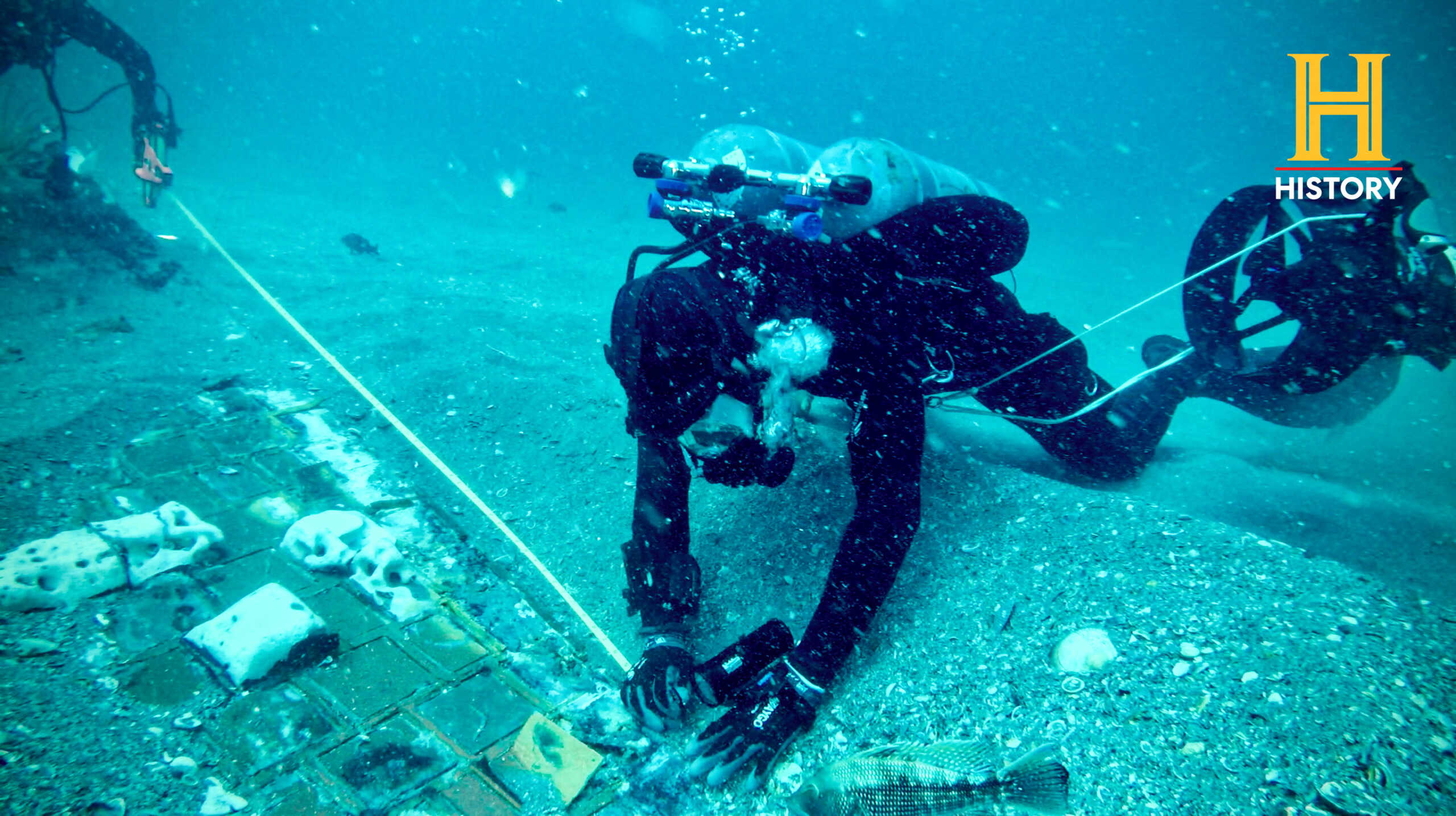 Underwater explorer and marine biologist Mike Barnette and wreck diver Jimmy Gadomski explore a twenty-foot segment of the 1986 Space Shuttle Challenger, the team discovered in the waters off the coast of Florida, U.S., during the filming a History Channel documentary called ?The Bermuda Triangle: Into Cursed Waters?, in this handout picture taken May, 2022. The History Channel