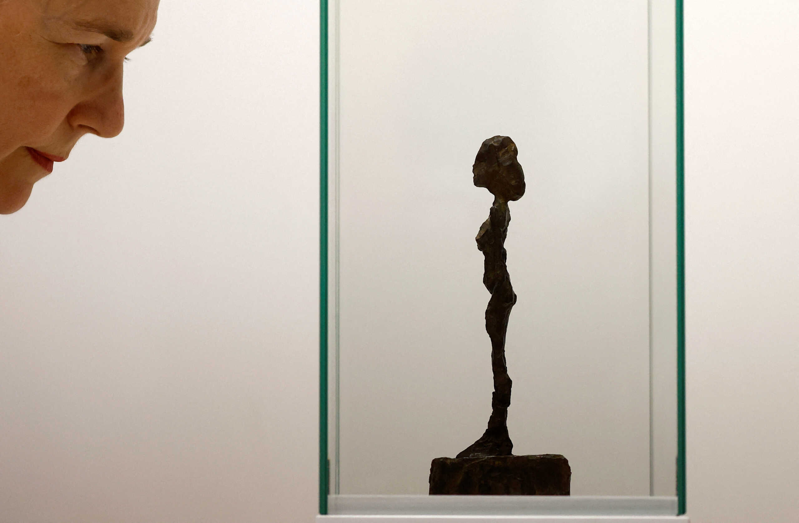A visitor looks at a bronze figurine (1953-1954) by artist Alberto Giacometti displayed by Kamel Mennour gallery as Paris+ par Art Basel international contemporary art fair opens in Paris, France, October 19, 2022. REUTERS