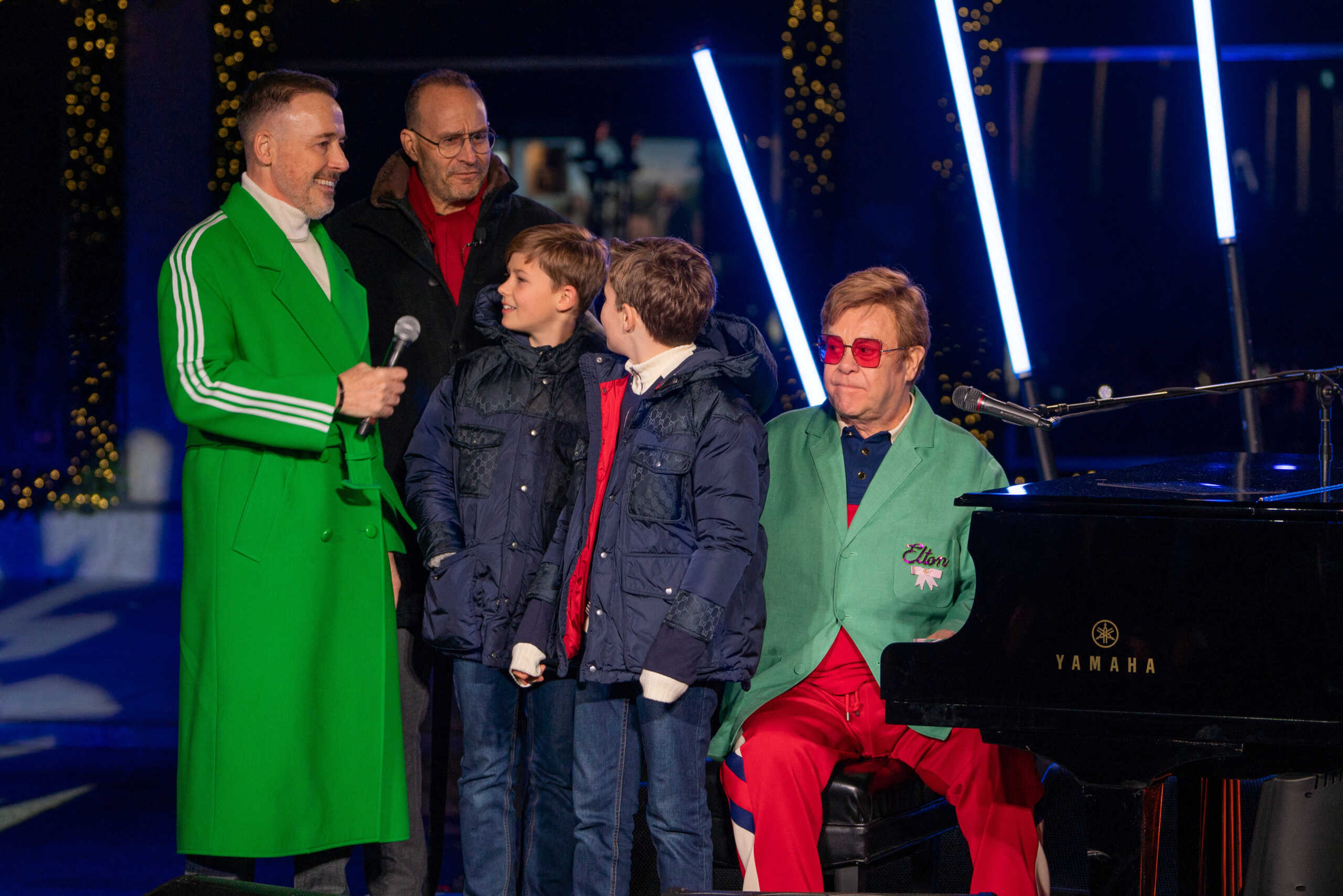 Singer Sir Elton John on stage with his family during an event to unveil the 2022 holiday windows displays at Saks 5th Avenue department store in midtown Manhattan, in New York City, New York, U.S., November 22, 2022. REUTERS