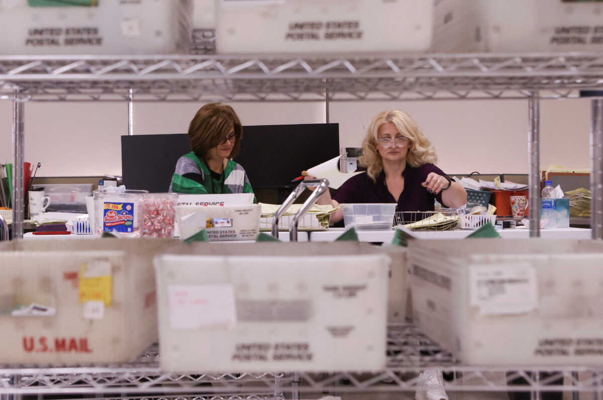 Staff process ballots for the U.S. midterm elections at the Maricopa County Tabulation and Election Center in Phoenix, Arizona, U.S., November 13, 2022. REUTERS