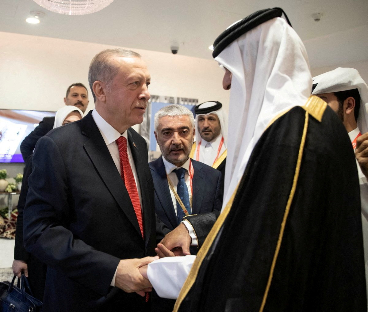 Turkey's President Tayyip Erdogan shakes hands with Qatari Emir Sheikh Tamim bin Hamad al-Thani on the sidelines of the World Cup in Doha, Qatar, November 20, 2022. Qatar News Agency